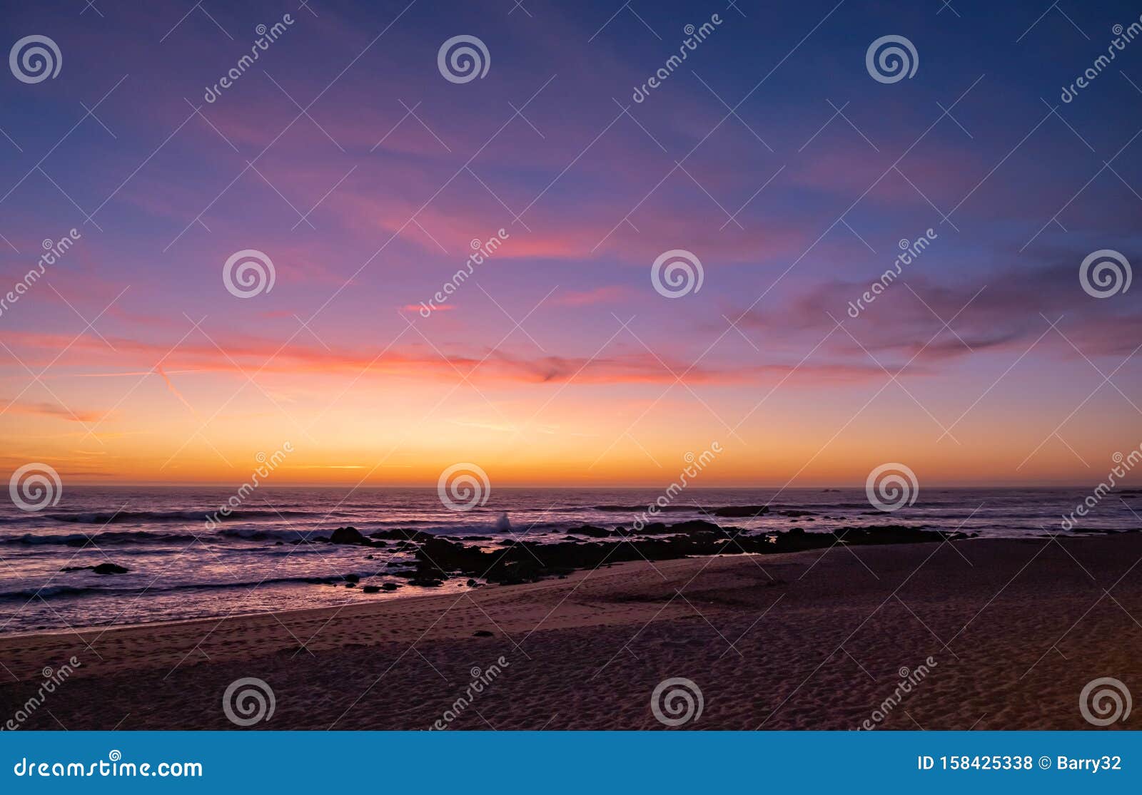 beautiful dusk over beach in summer with vivid blue orange gradient sky and reflections