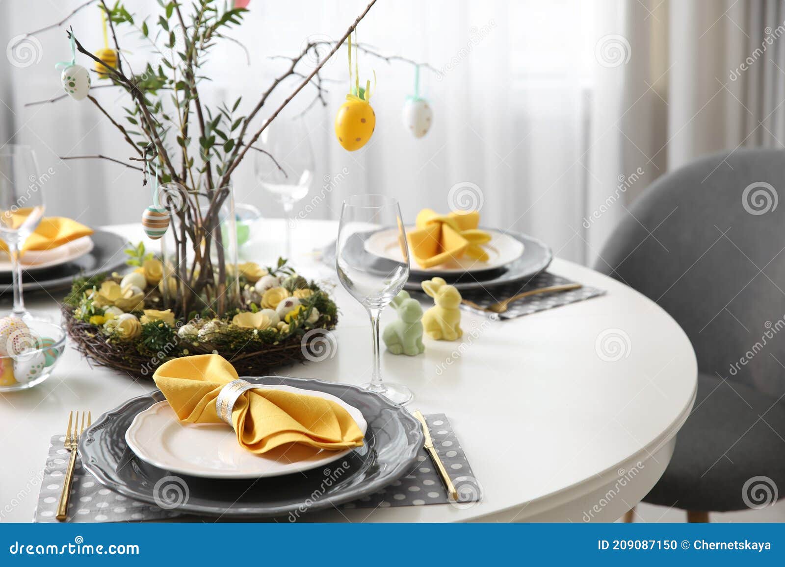 Beautiful Easter Table Setting with Floral Decor Indoors Stock Photo