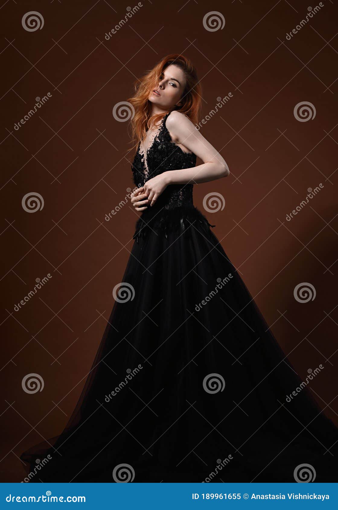 Beautiful Elegant Young Model with Bright Redhead Hairstyle Posing in  Fashion Chic Black Wedding Dress with Long Skirt on Studio Stock Image -  Image of adult, makeup: 189961655