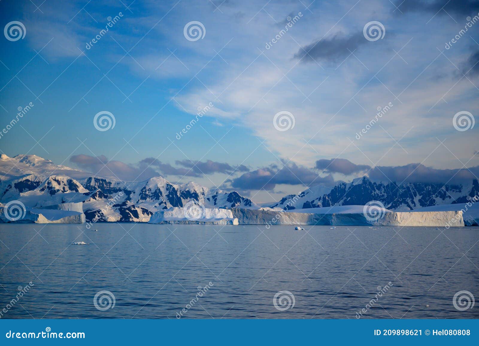 antarctic landscape with snowcapped mountains, icebergs and glacier near andvor bay, antactic peninsular