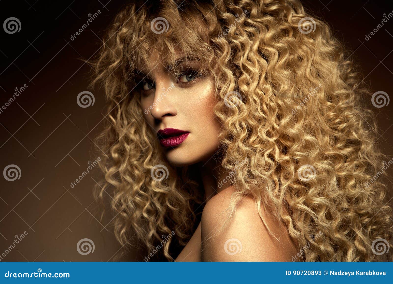 girl with curly blonde hair and blue eyes