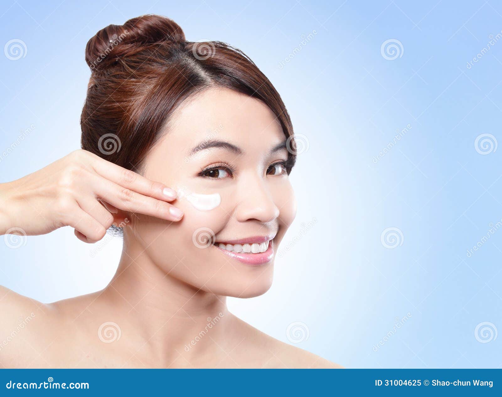 beautiful face of girl applying moisturize cream