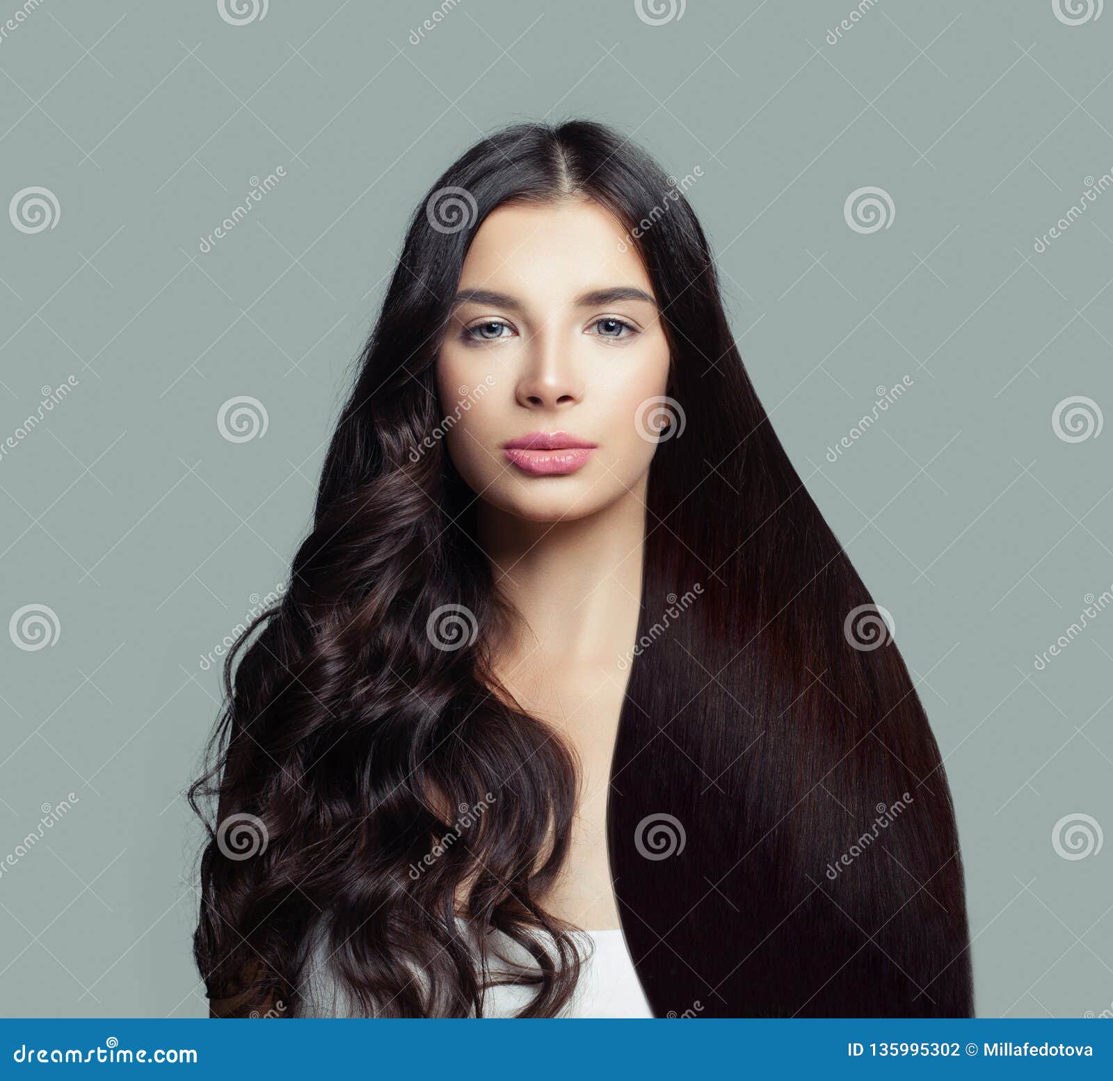 beautiful fashion model woman with long straight hair and perfect curly hairstyle on blue background