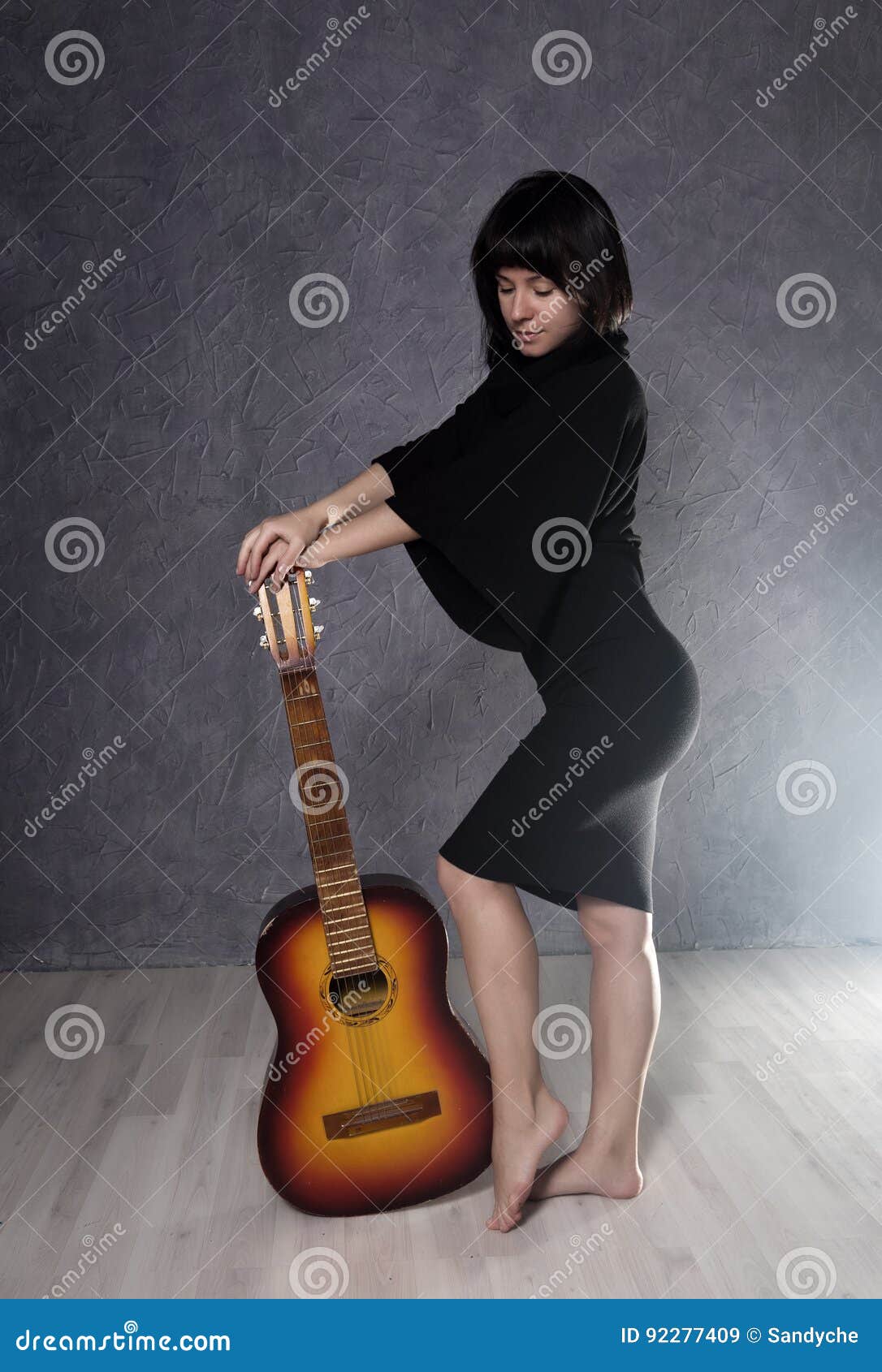 Asian girl sitting on the balcony playing guitar Stock Photo free download