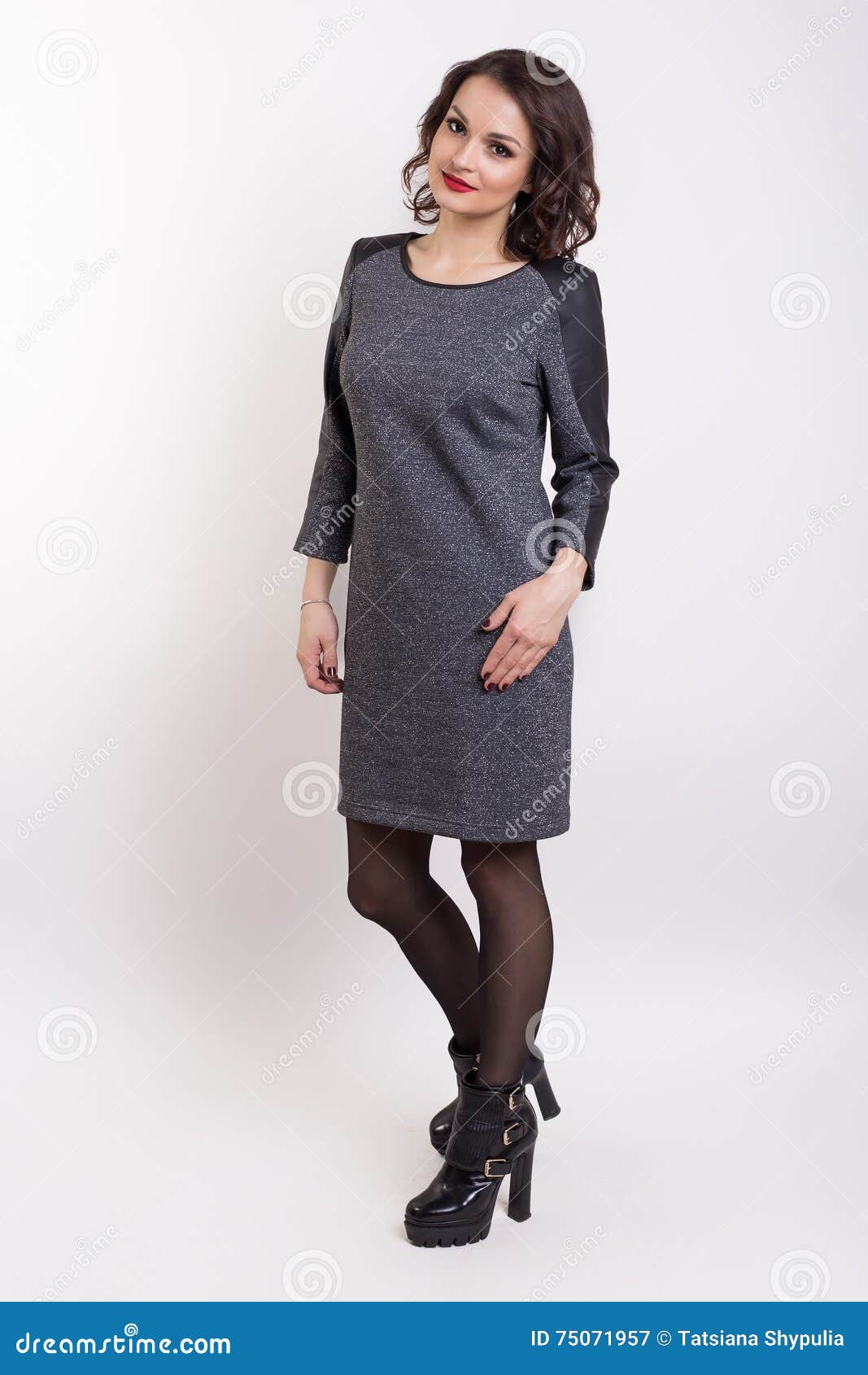Beautiful Fashionable Girl In A Dress For A Catalog Shoot On A White