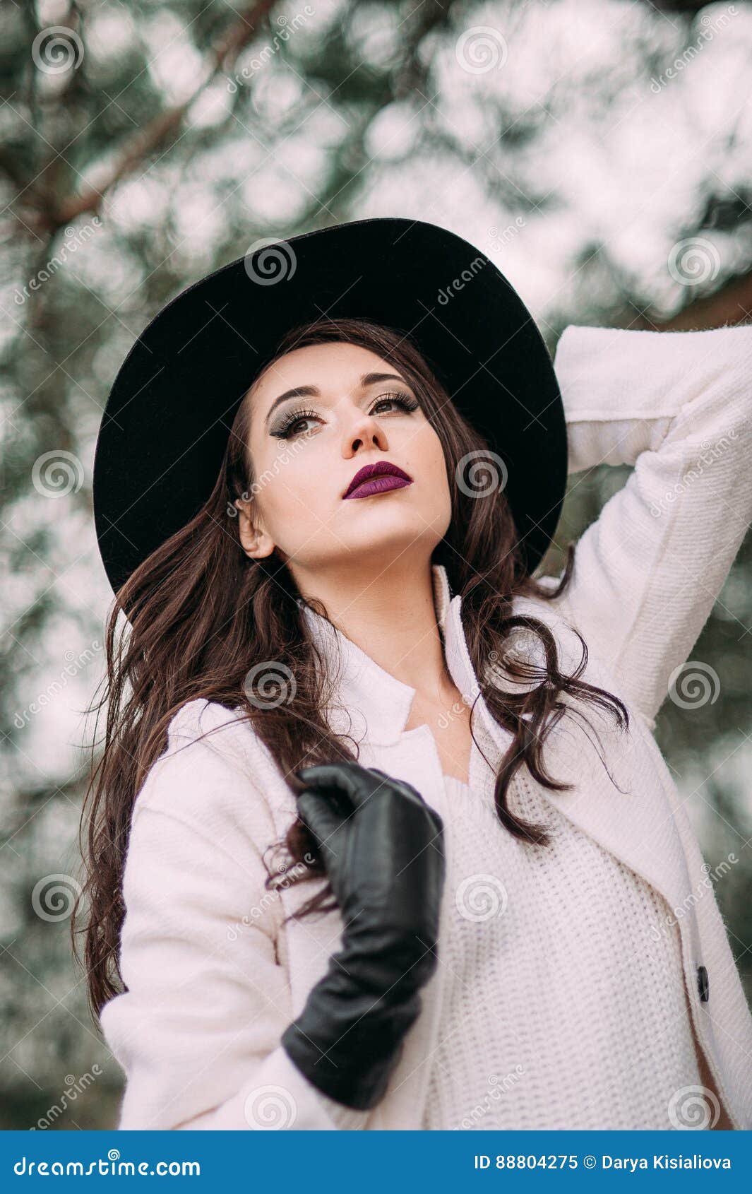 Beautiful Fashionable Woman in a Black Hat and White Coat Posing ...