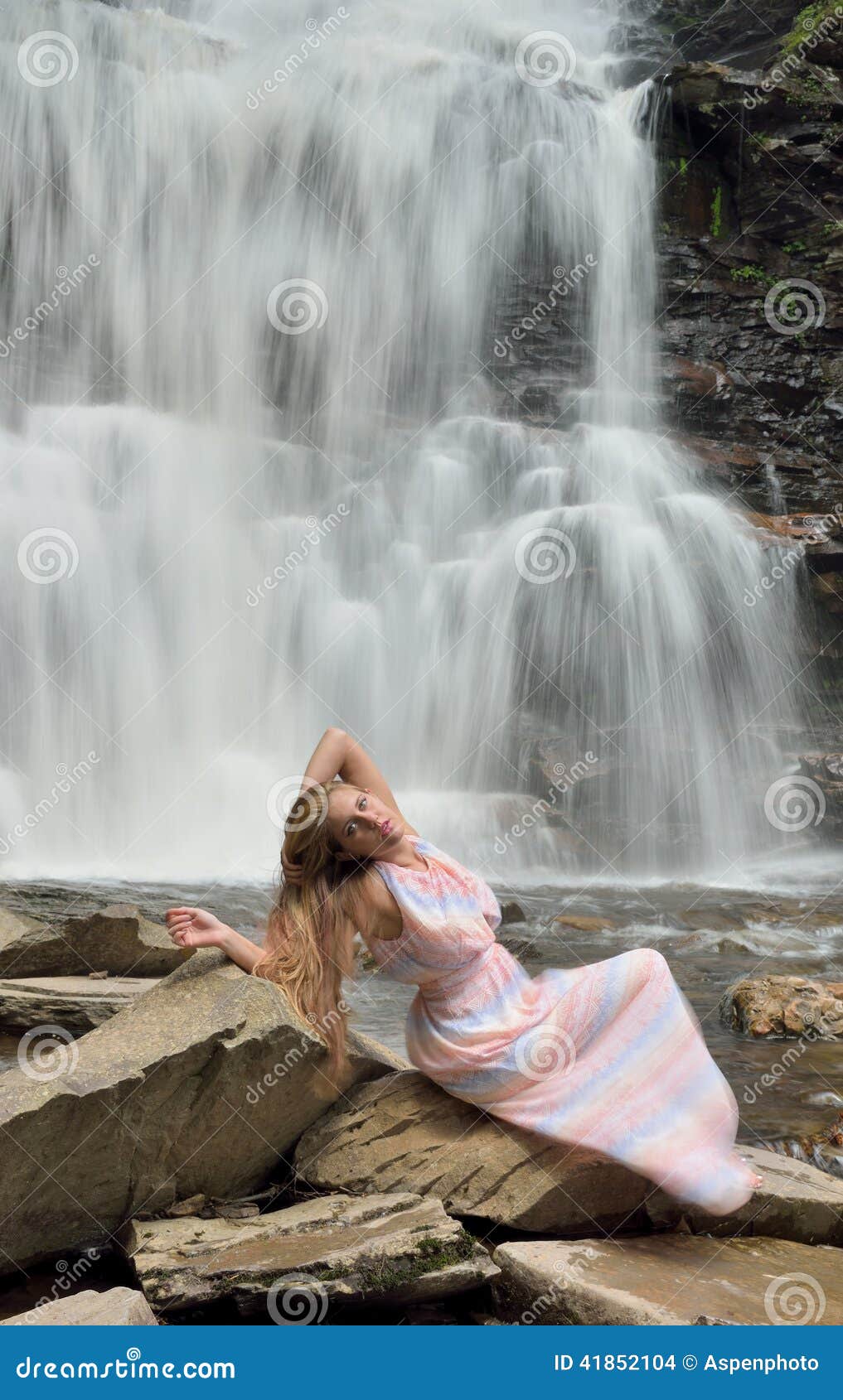 Premium Photo | Feel the moment. cute brunette sitting on big stone in  front of waterfall and posing on camera
