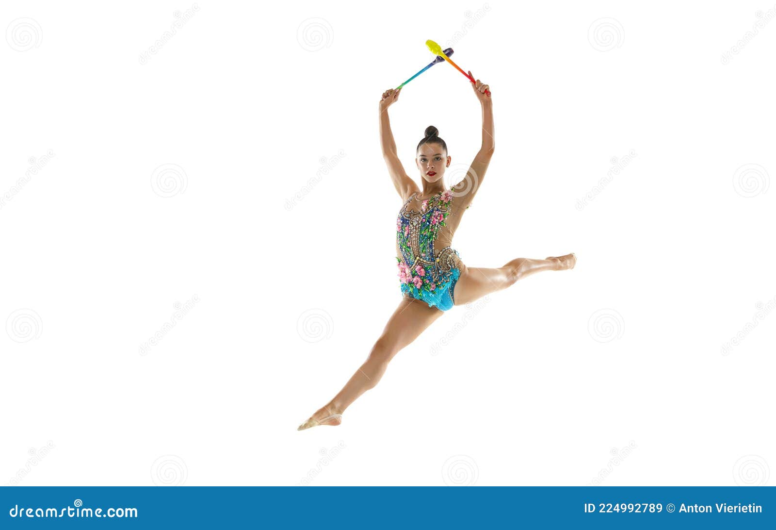 beautiful female rhythmic gymnast with clubs in motion and action  white studio background.