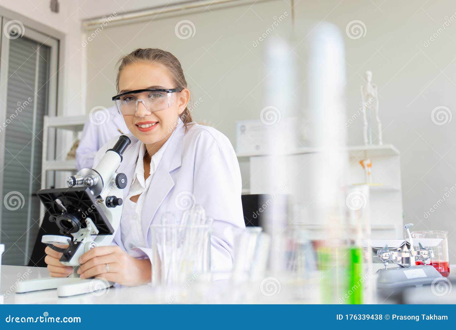 Beautiful Female Scientist is Operating in a Science Lab with Various