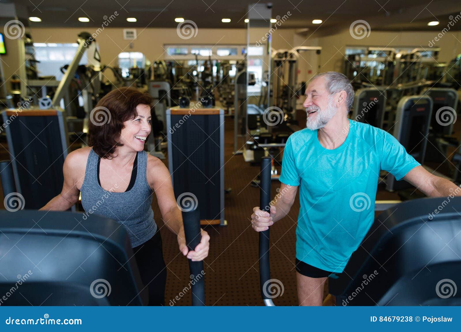 French And Fit Senior Beautiful Fit Senior Couple in Gym Doing Cardio Work Out. Stock Photo