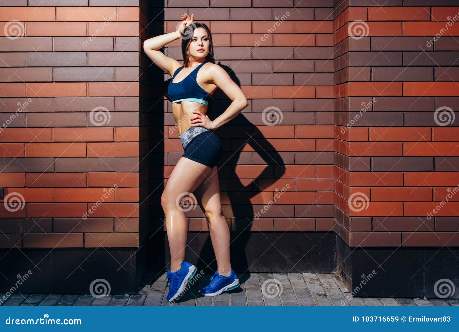 Beautiful Fitness Model Posing Against a Brick Wall Background. Stock ...