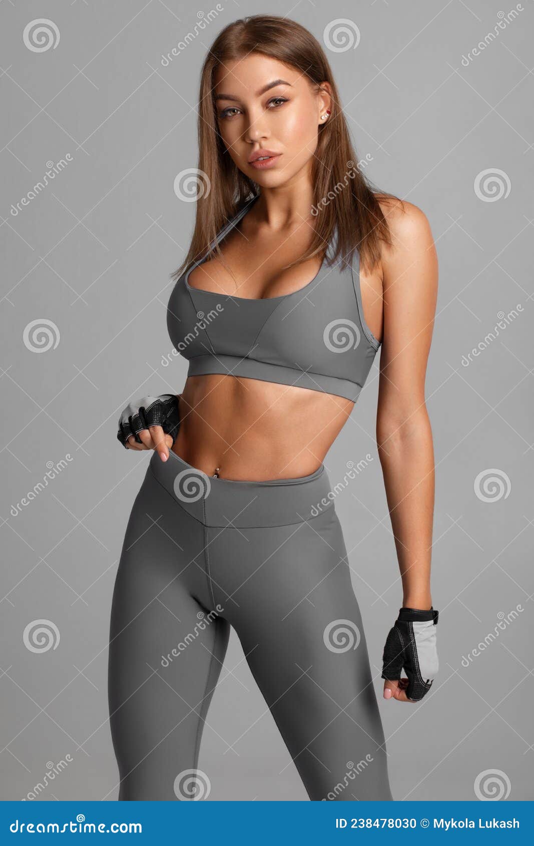 beautiful fitness woman. athletic girl on the gray background