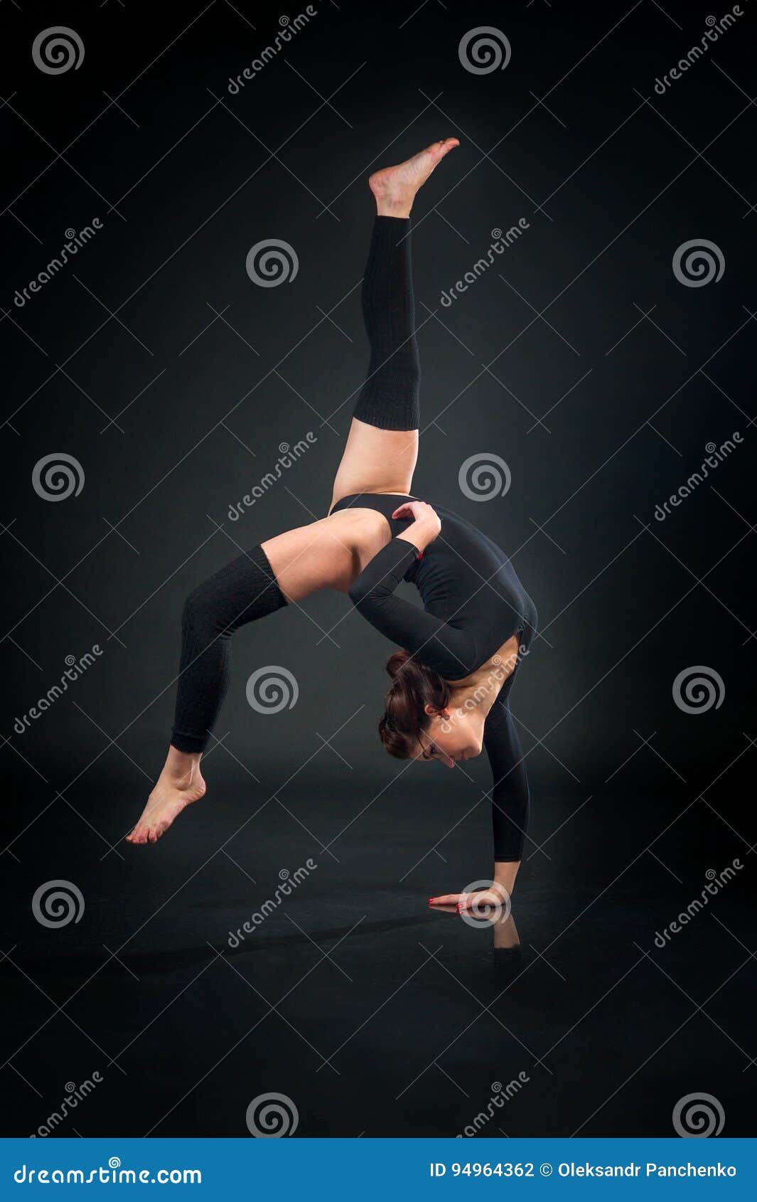 Flexible Acrobatic Gymnast Sitting In A Half Split And Smiling To The Camera While Wearing A