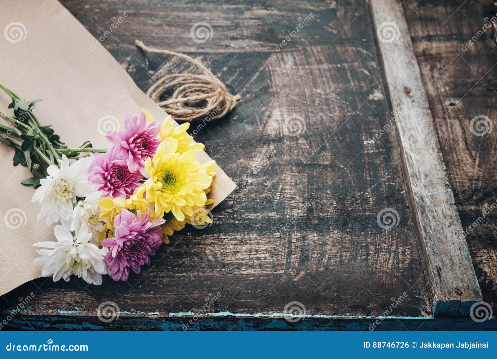 Bouquet Of Beautiful Dry Flowers Wrapped In Brown Paper Isolated
