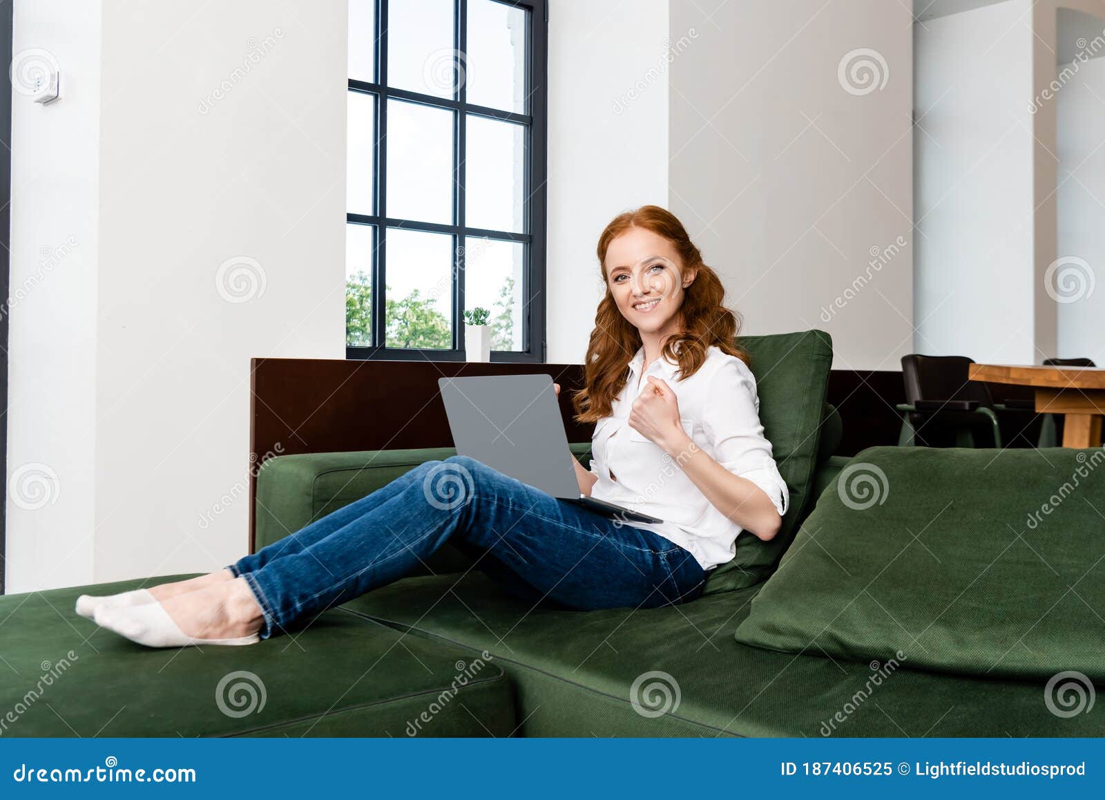 freelancer smiling at camera while showing