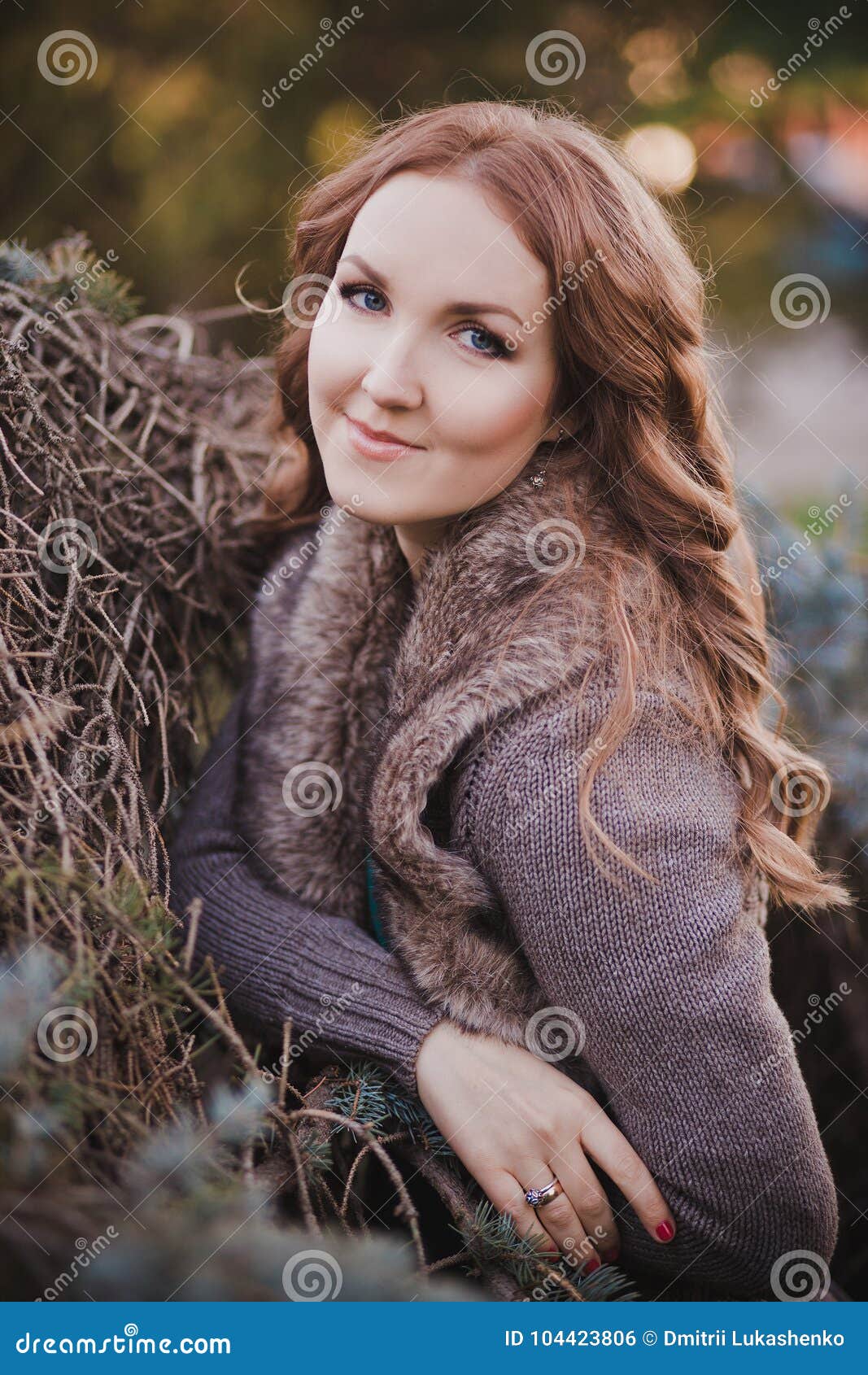 beautiful genuine lady mystic with curly brunette hairs and adorable eyes dressed in fancy stylish warm clothes with fur on neck l