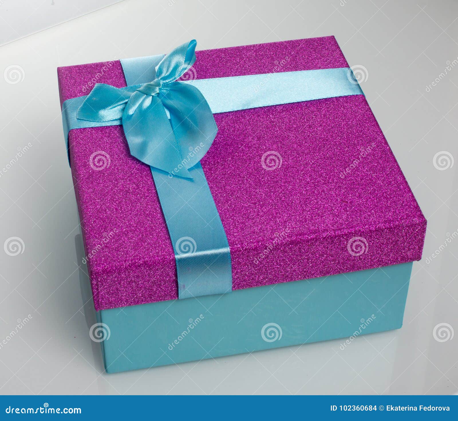 A Beautiful Gift Box In Blue, With A Purple Ribbon And Bow. Beautiful Christmas Card On White ...