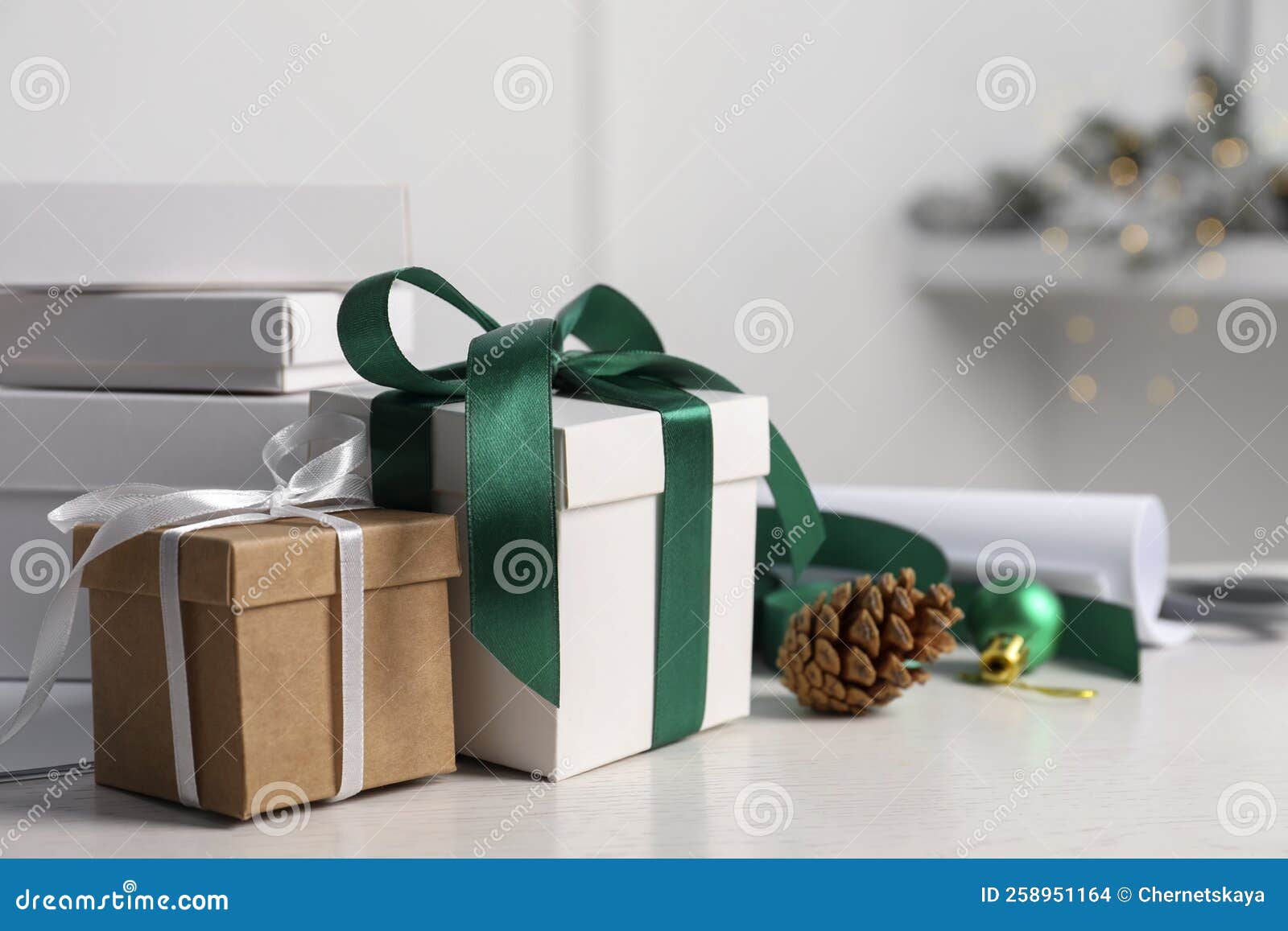 Beautiful Gift Boxes and Christmas Decorations on White Table Stock