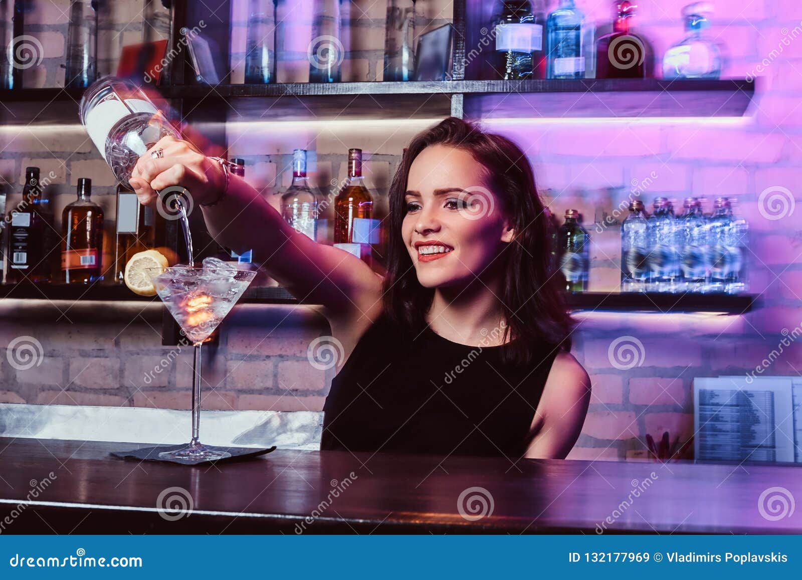 A Beautiful Girl Bartender Prepares an Alcoholic Cocktail with Vodka ...