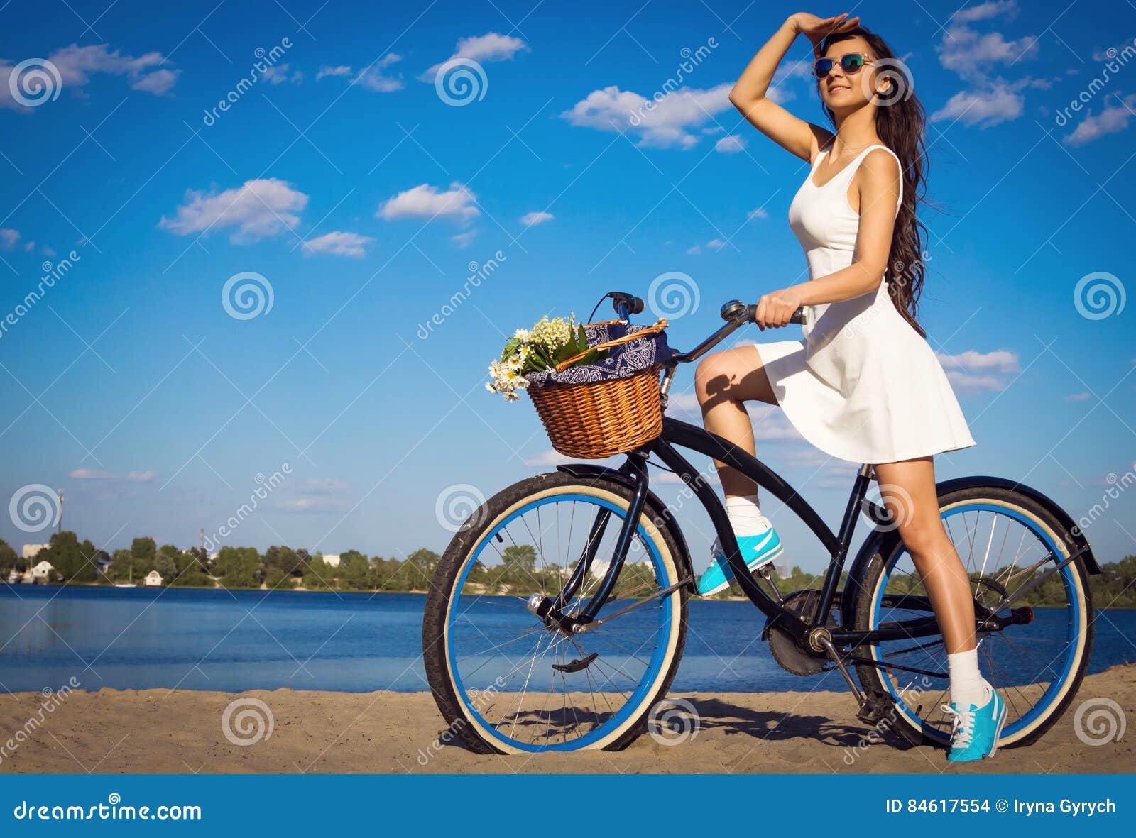 beautiful girl on the beach with cruiser bicycle