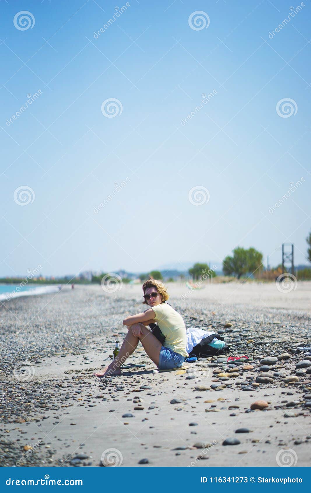 Beautiful Girl on the Beach Watching the Sea Waves and Surf. Stock ...