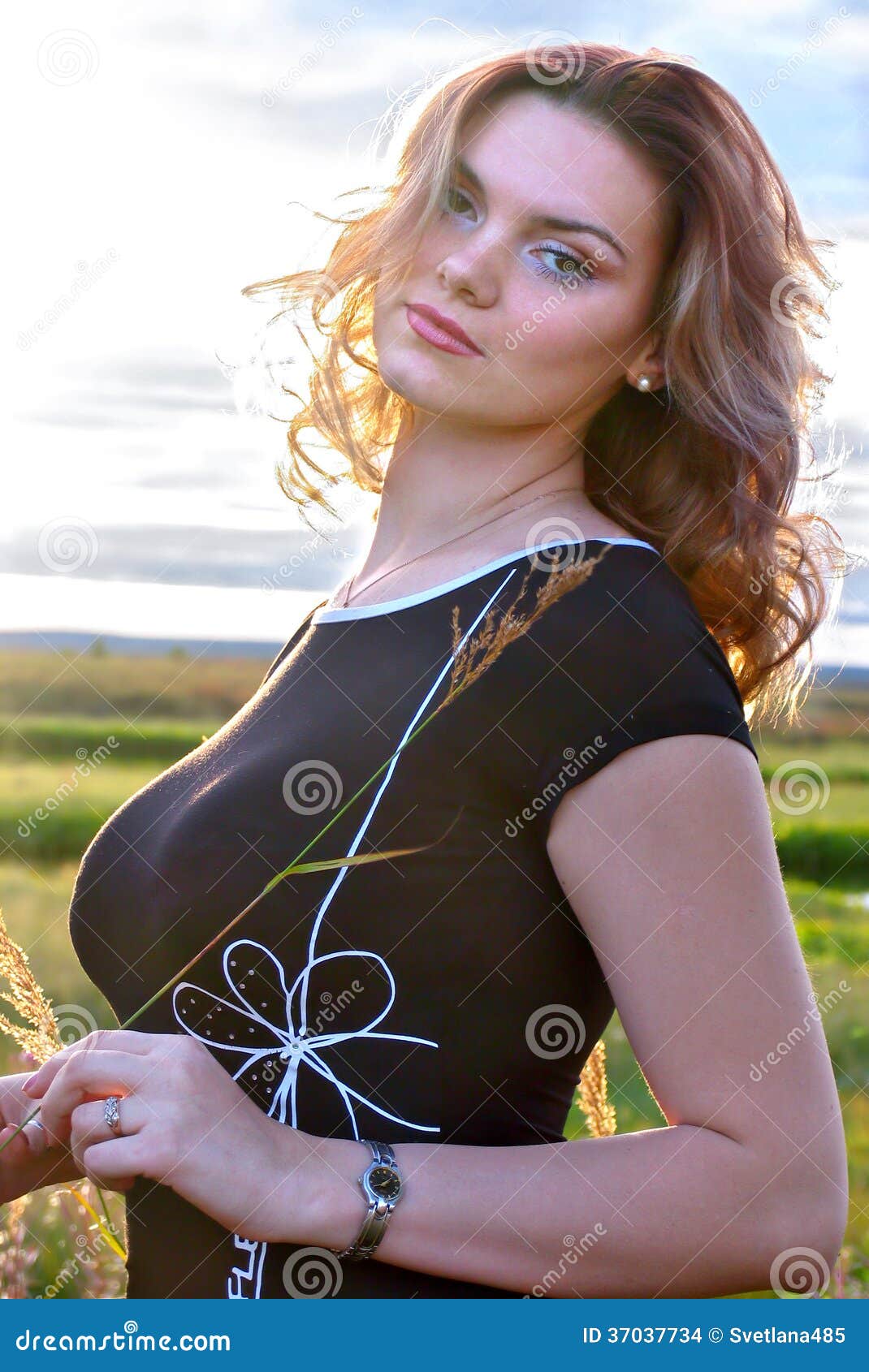 Beautiful Girl with Big Breasts Closeup on Nature Background