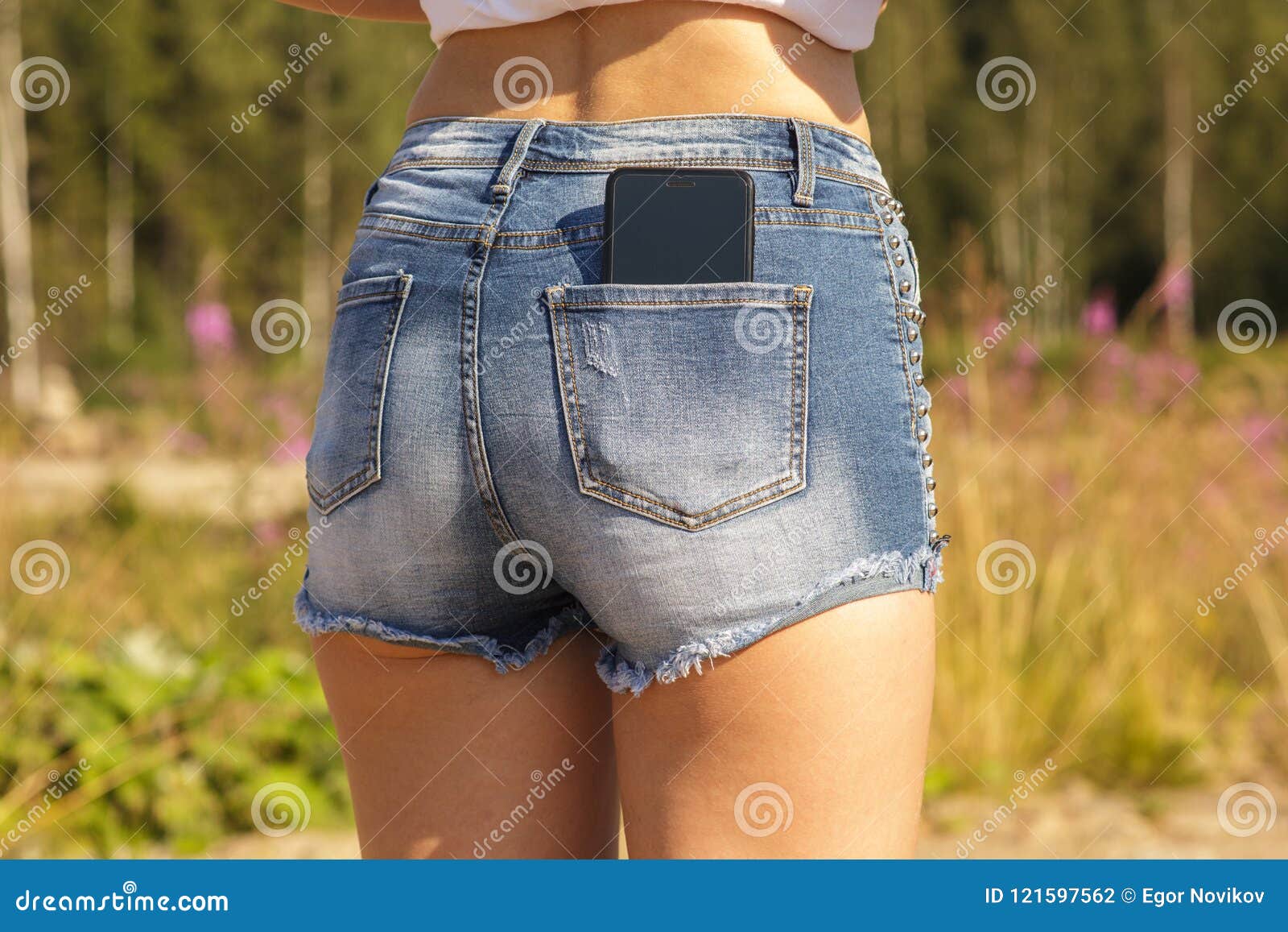 Beautiful Girl With A Black Smartphone In The Back Pocket Of A Jeans Stock Photo - Image of ...