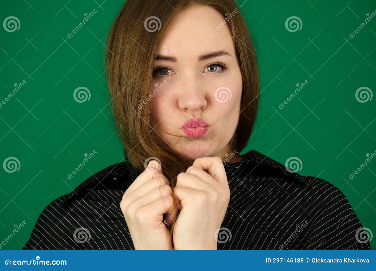 Beautiful Girl Blow Kisses Woman On A Green Background Chromakey In A Black Striped Mens Shirt