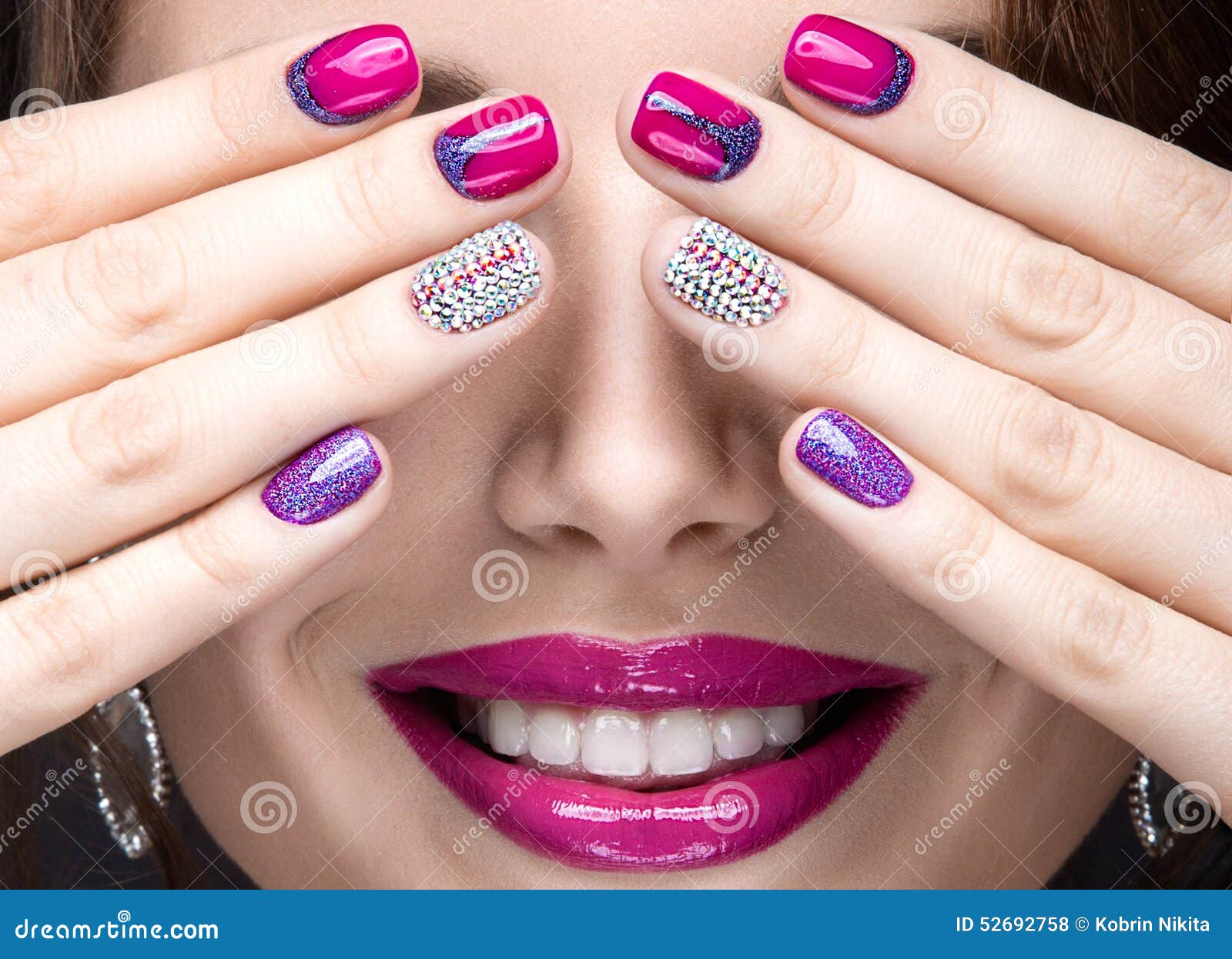 beautiful girl with a bright evening make-up and pink manicure with rhinestones. nail . beauty face.