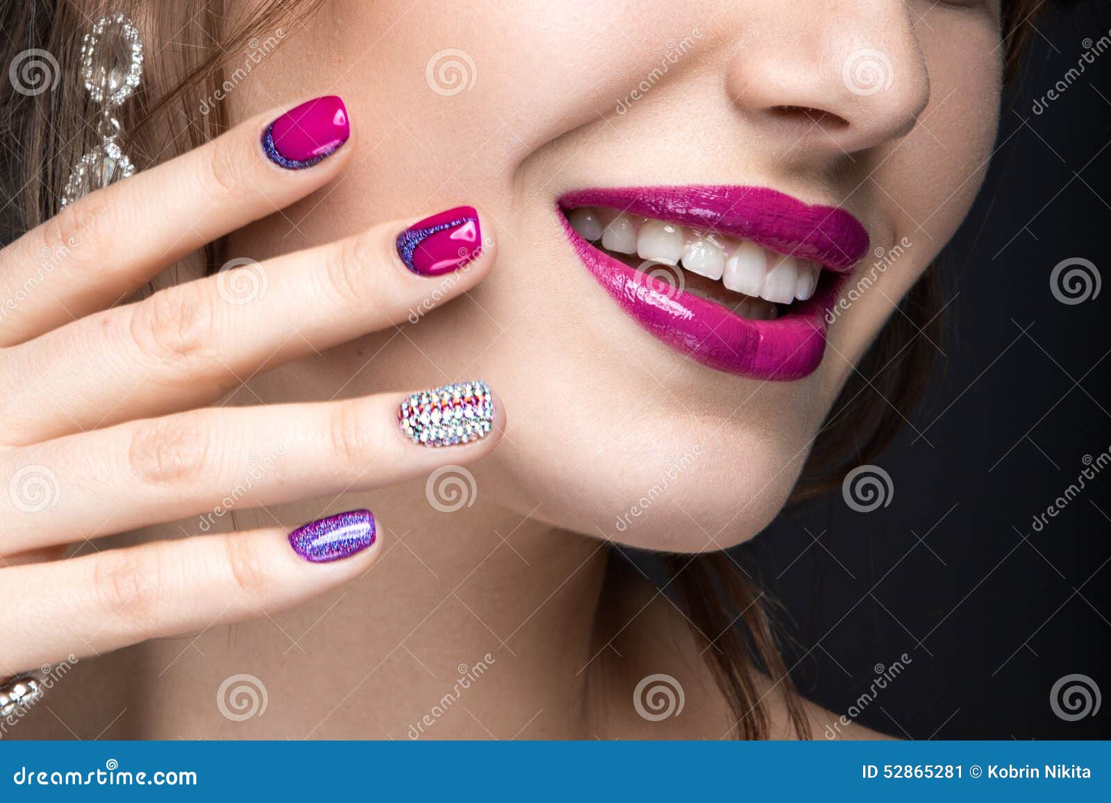 beautiful girl with a bright evening make-up and pink manicure with rhinestones. nail . beauty face.