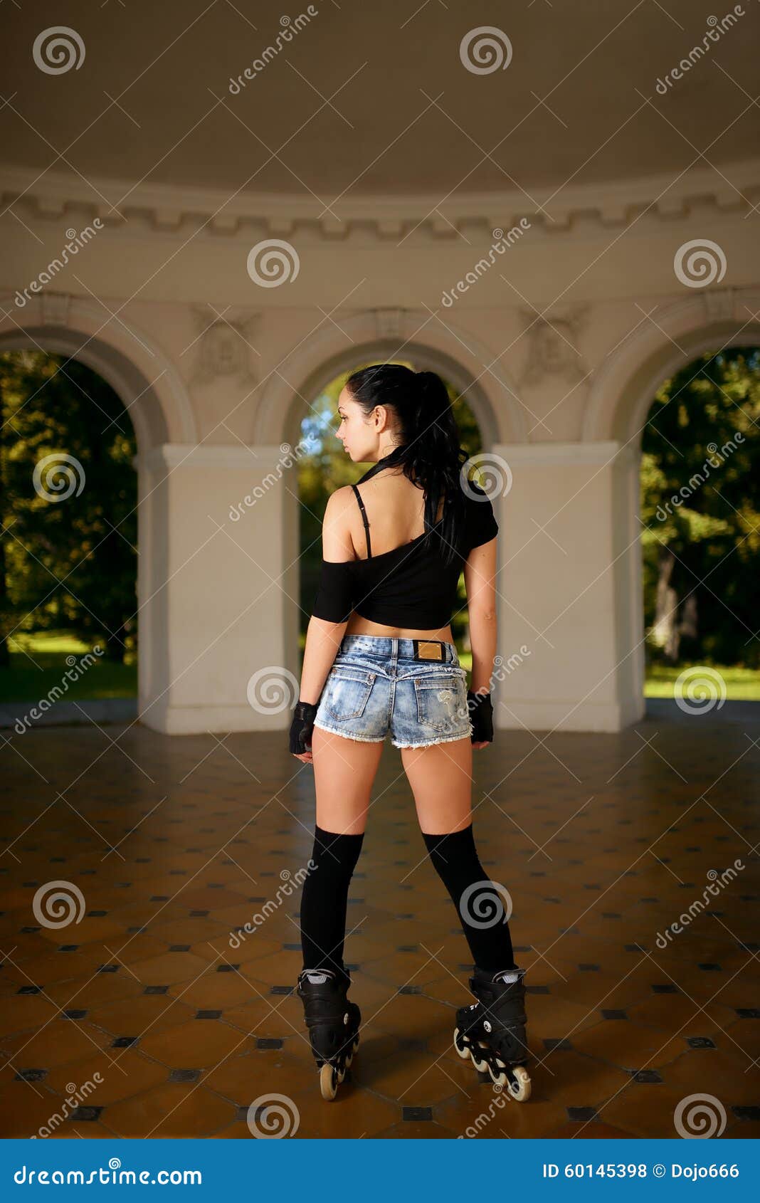 beautiful girl in cut-offs and on roller skates in city park