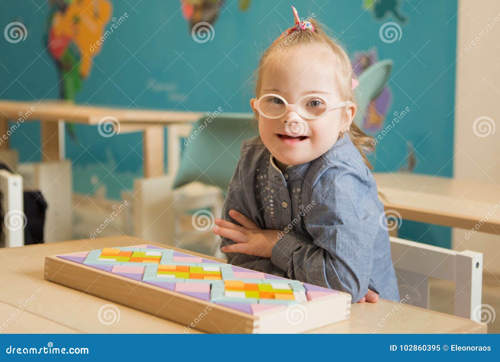beautiful girl with down syndrome engaged in class