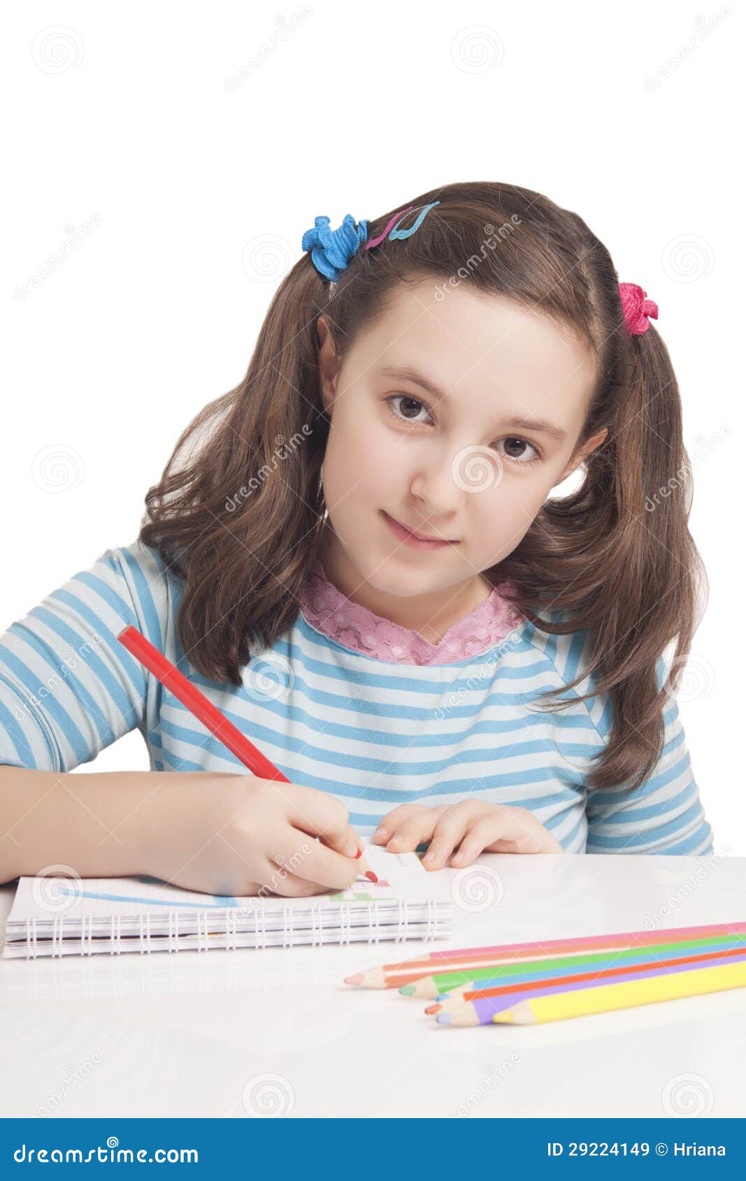 beautiful girl is drawing with color pencils