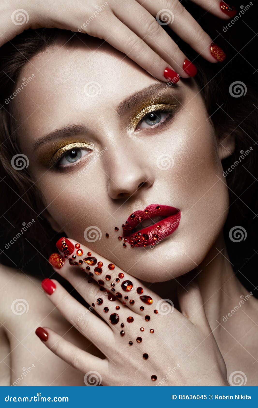 beautiful girl with evening make-up, red lips in rhinestones and  manicure nails. beauty face.