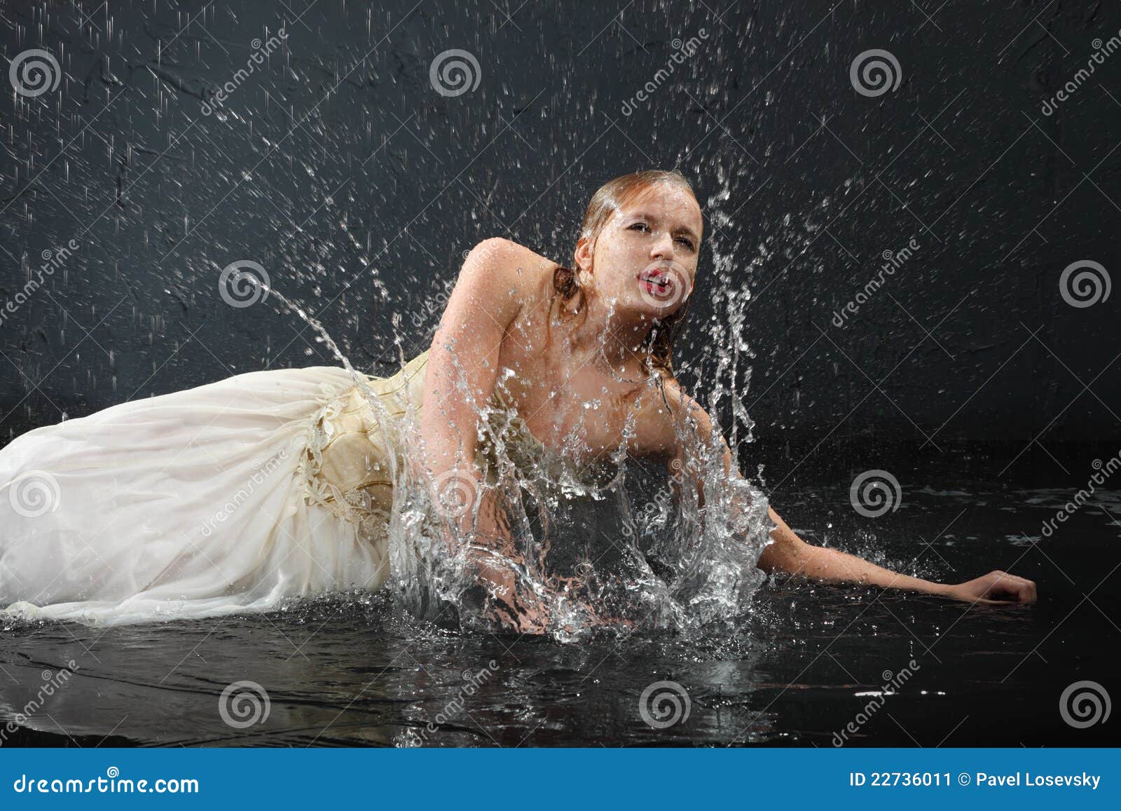 beautiful girl lies on floor and sprays water