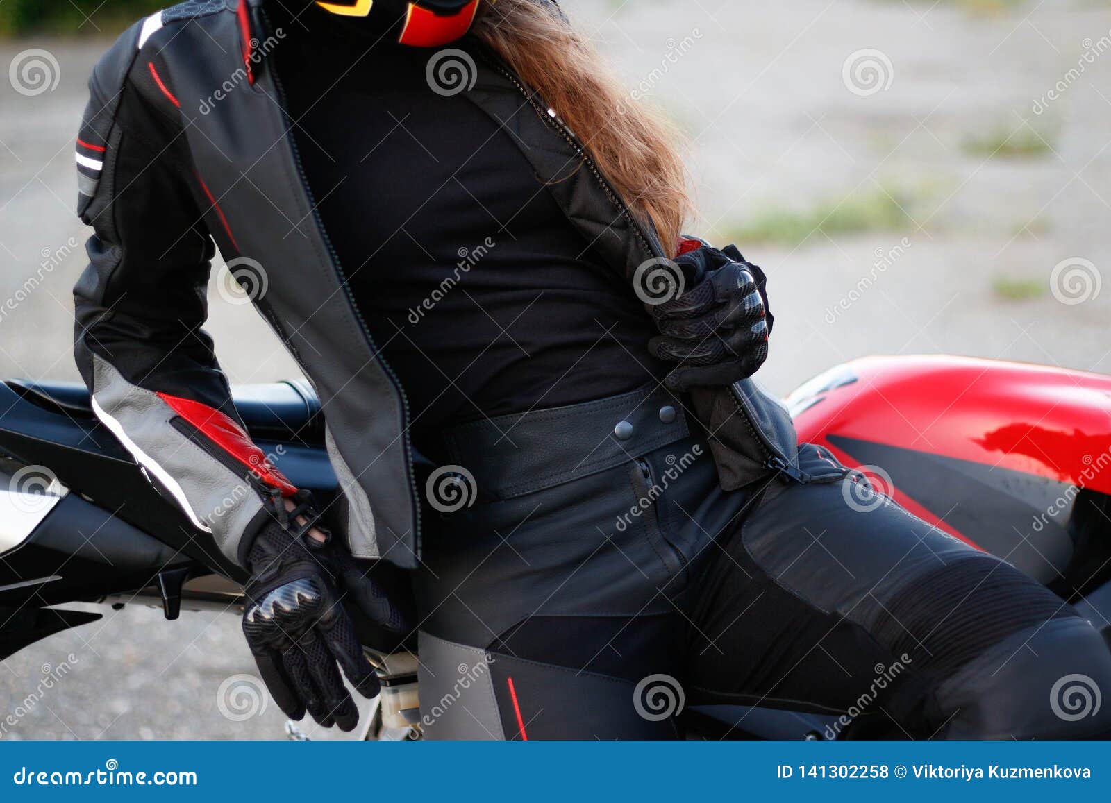 Beautiful Girl Motorcyclist in Full Gear and Helmet on a Red and Black ...