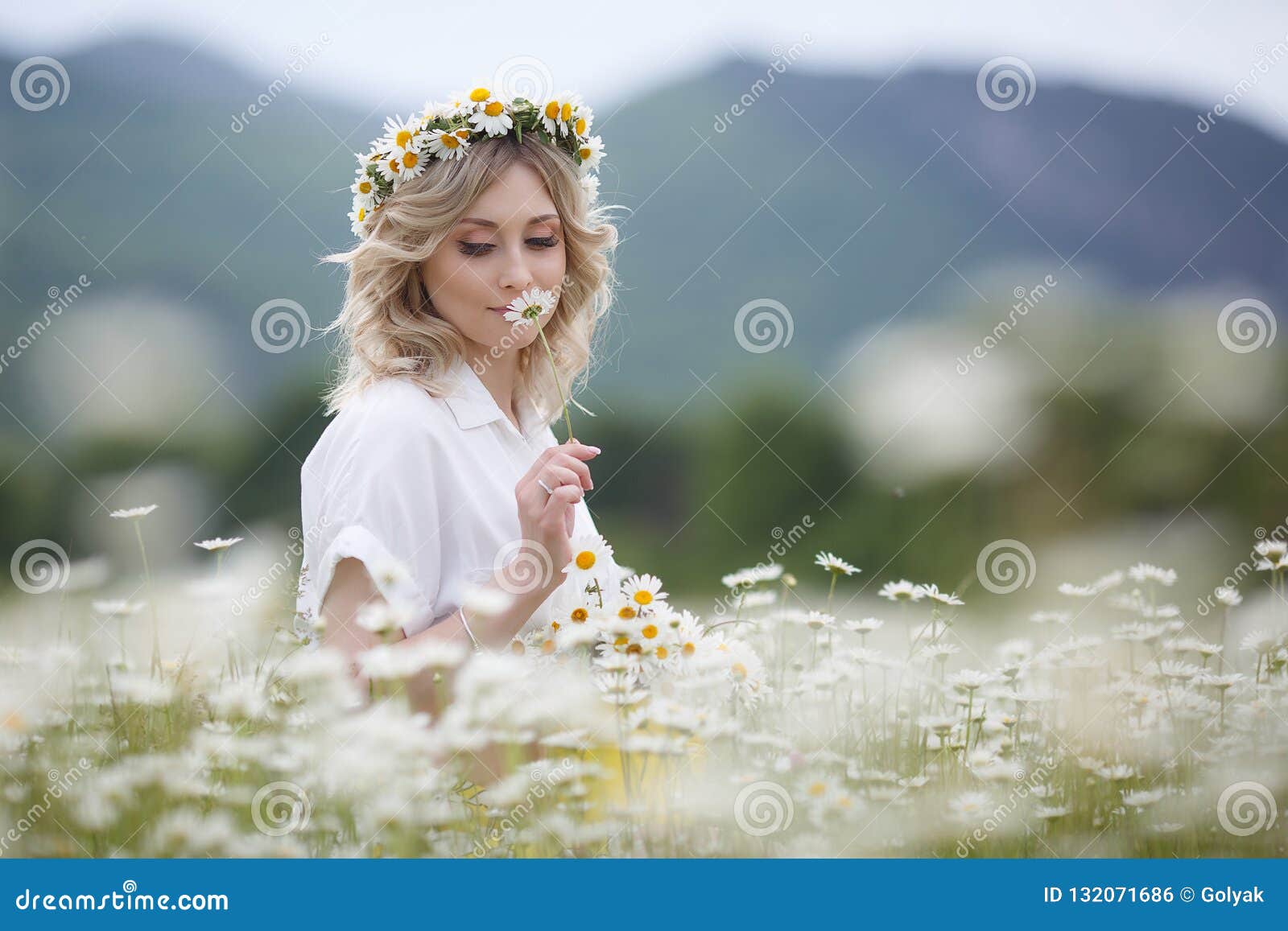 Beautiful Woman Outdoors with a Bouquet of White Daisies on a Blooming ...