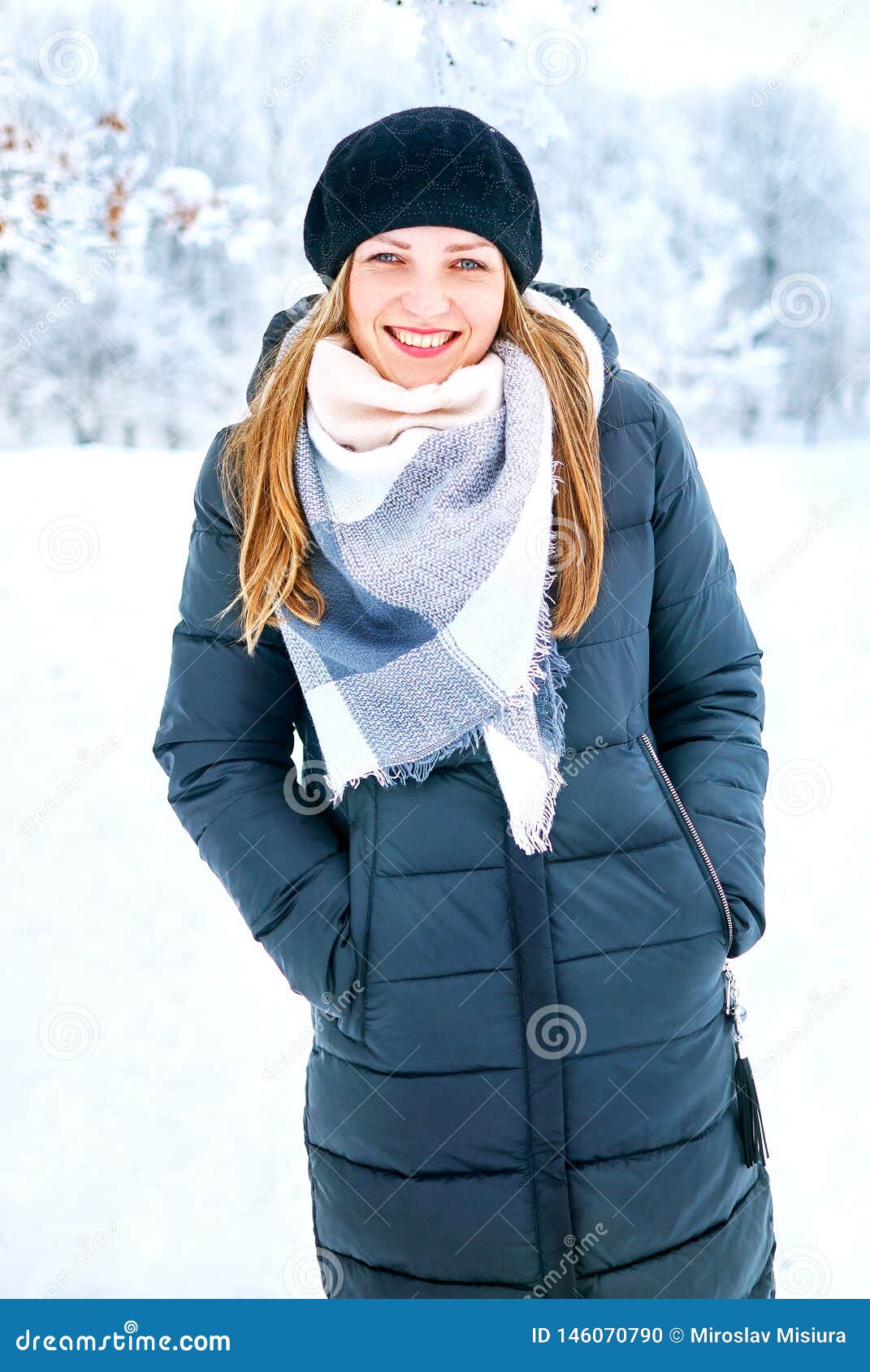 Young beautiful woman in golden jacket with fur hood poses outdoors in  winter Stock Photo - Alamy