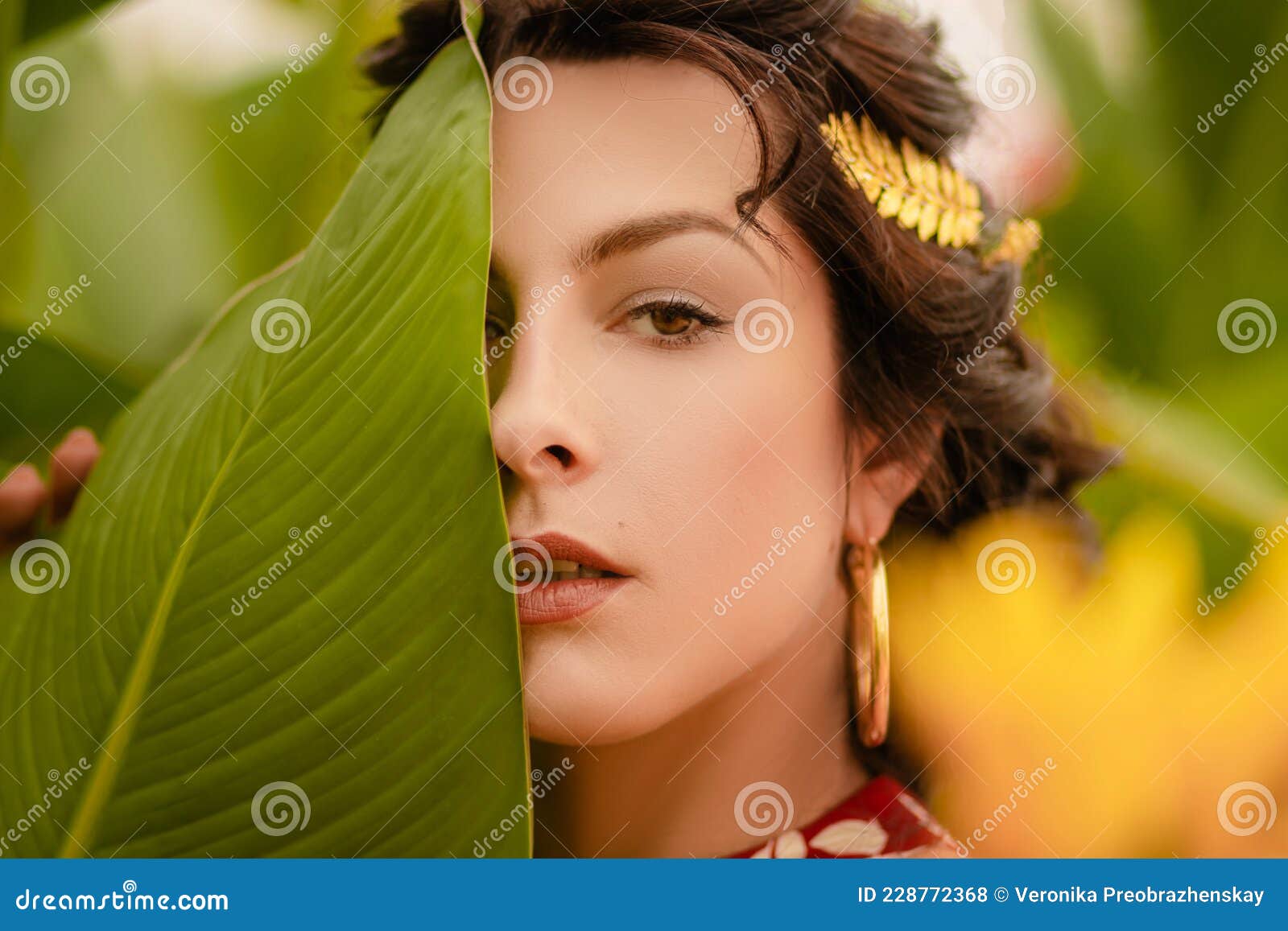 A Beautiful Girl In A Red Dress And With Earrings In The Rings In The Greenhouse Woman In