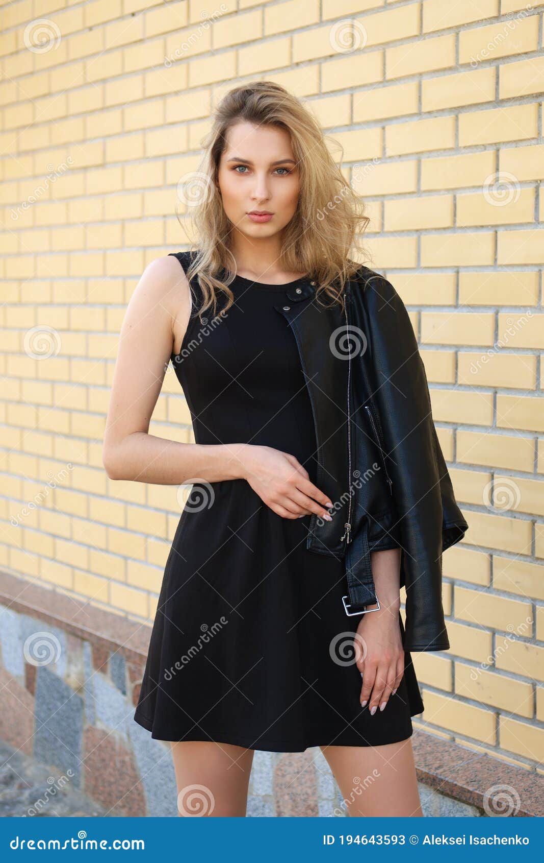 Beautiful Girl in Short Black Dress and Leather Jacket on the Street ...