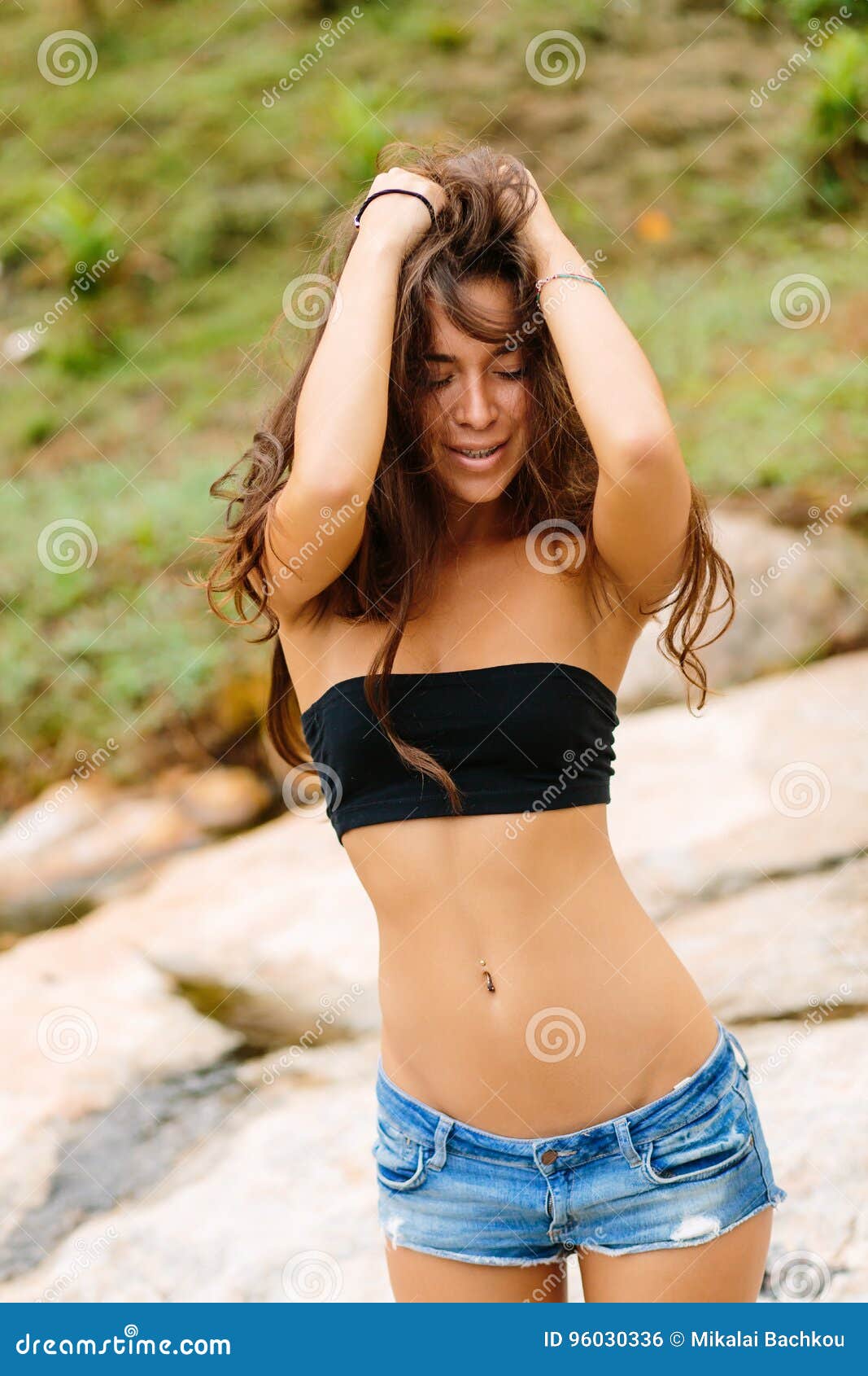 Beautiful Girl in Short Shorts Walk Near Stones. Stock Photo