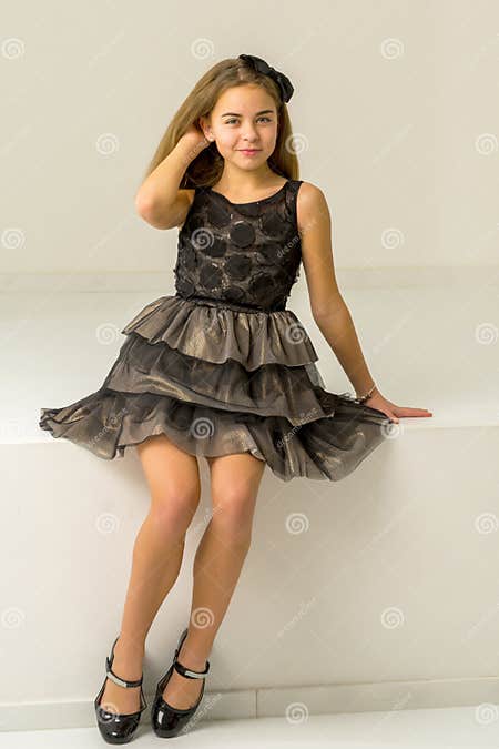 Cute Little Girl is Sitting in the Studio on the White Stairs. Style ...