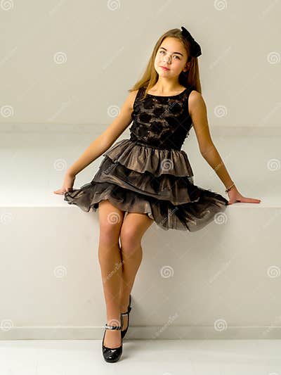 Cute Little Girl is Sitting in the Studio on the White Stairs. Style ...