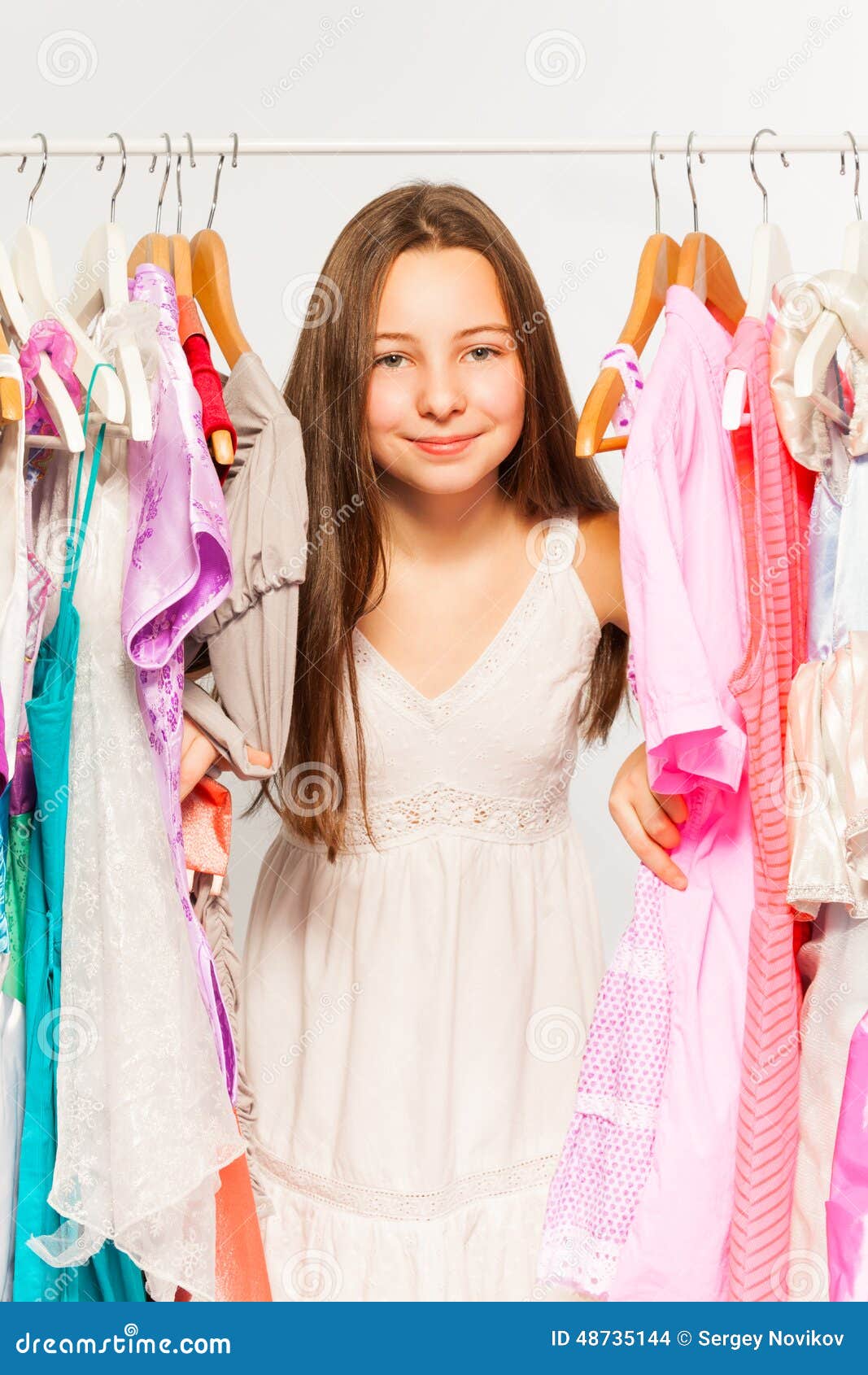 Beautiful Girl Stands Among Hangers With Clothes  Stock 