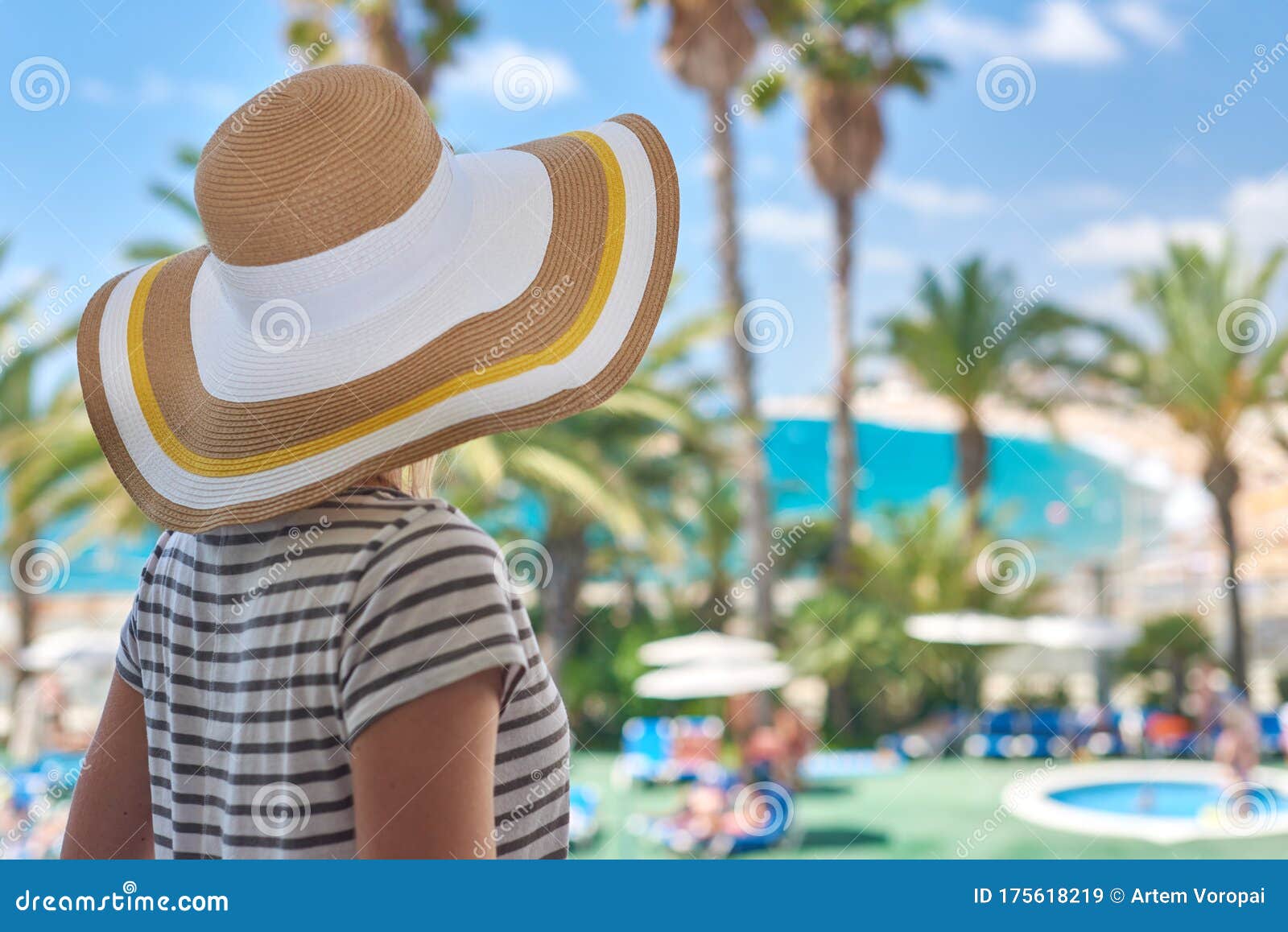 beautiful girl in sun hat enjoying amazing sea view
