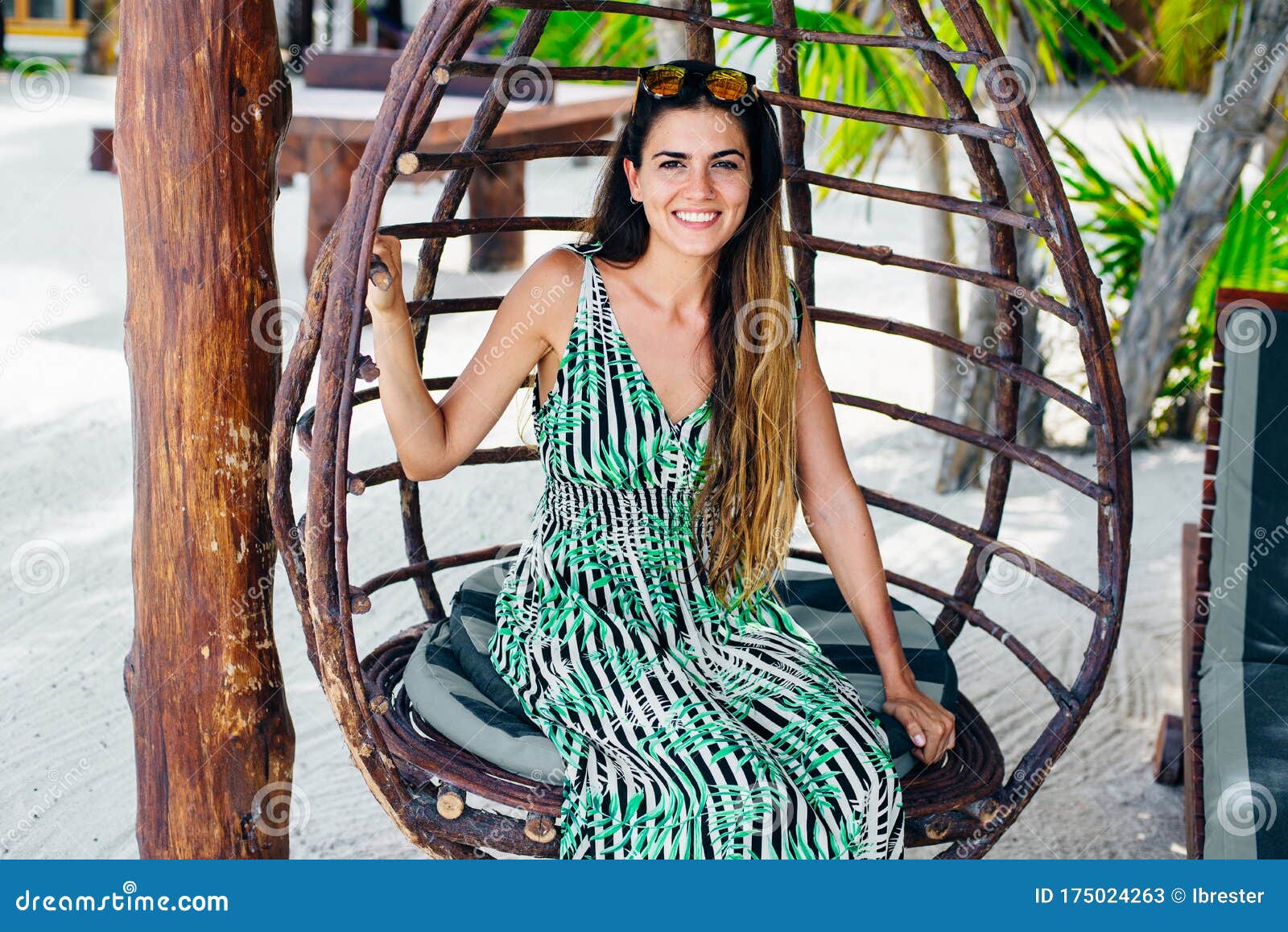 Beautiful Girl In Sunglasses In A Bright Dress On A White