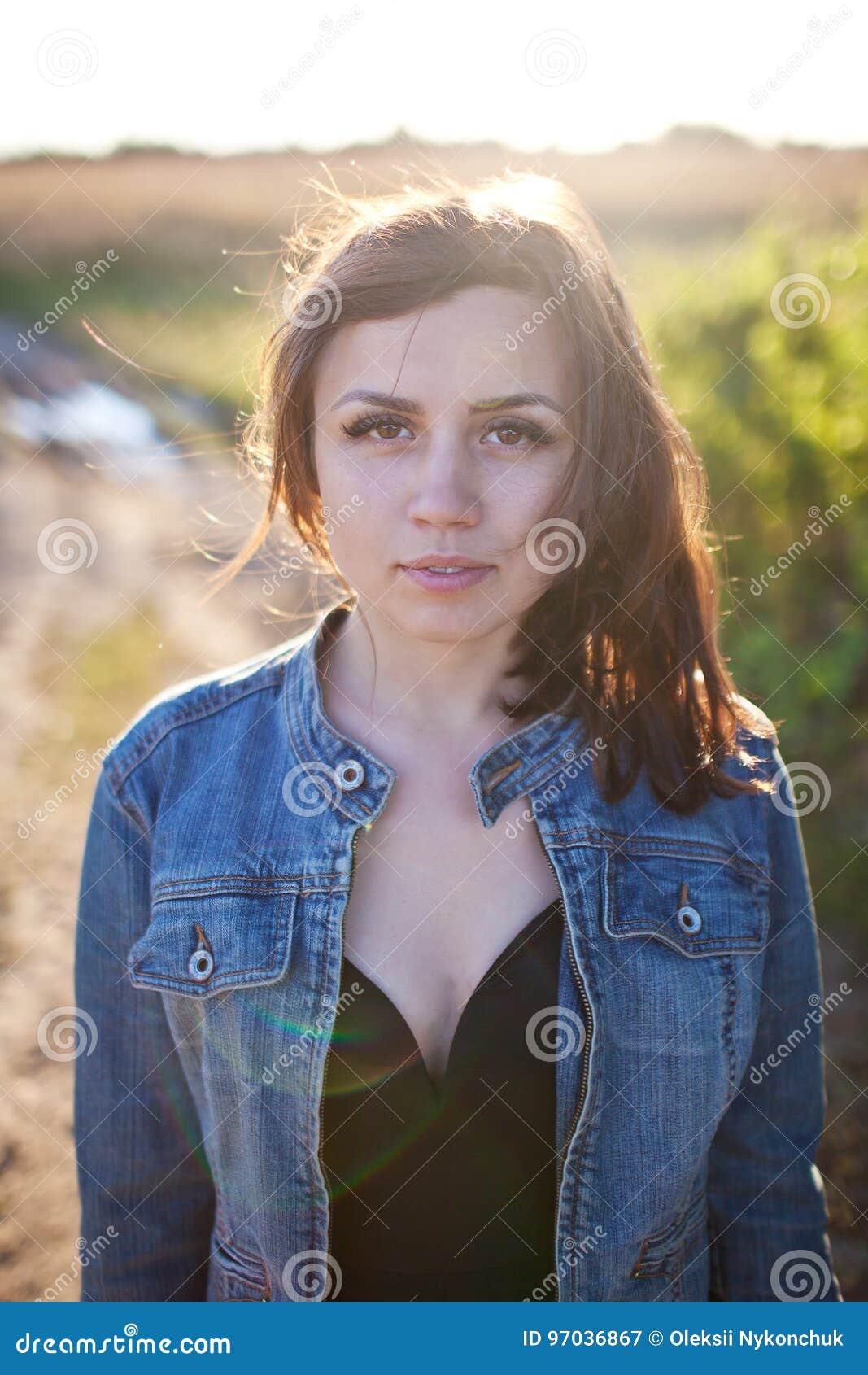 Beautiful Girl On Sunset Background In A Denim Jacket Stock Image