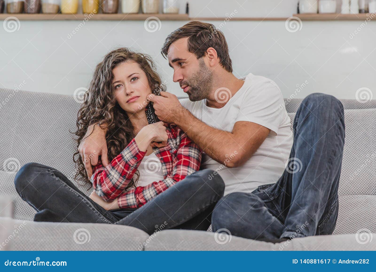 Beautiful Girl and a Young Man Sitting on the Couch and Watch TV ...