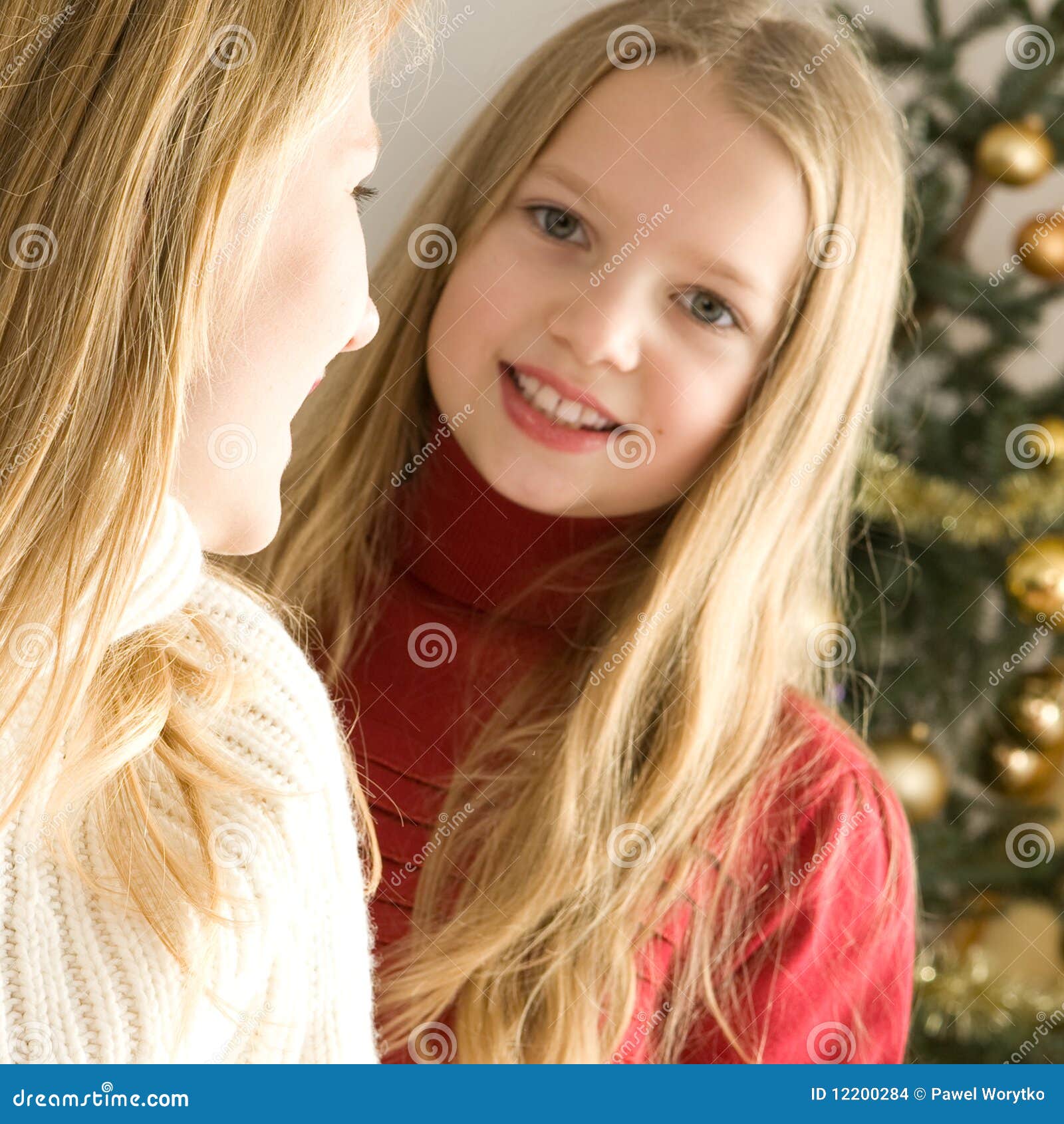 Two Beautiful Girls Lying Next To A Christmas Tree Stock 