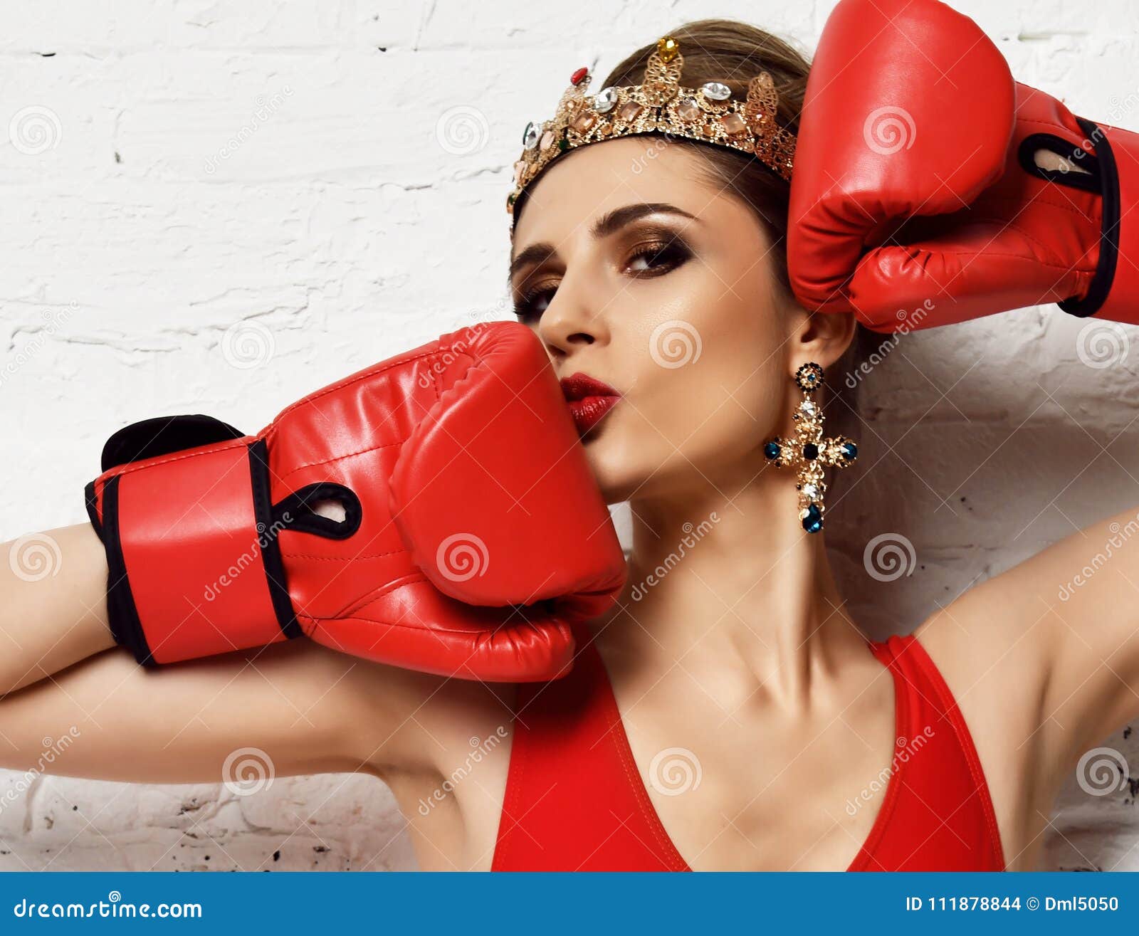 beautiful glamour sexy woman red boxing gloves fashion gold crown earrings brick wall beautiful glamour sexy woman 111878844